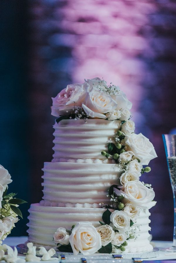 A white wedding cake with white flowers on top at a Key West wedding.