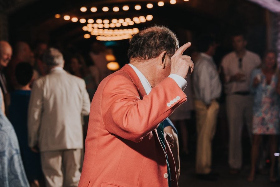 A man in a red suit dancing at a Key West wedding.