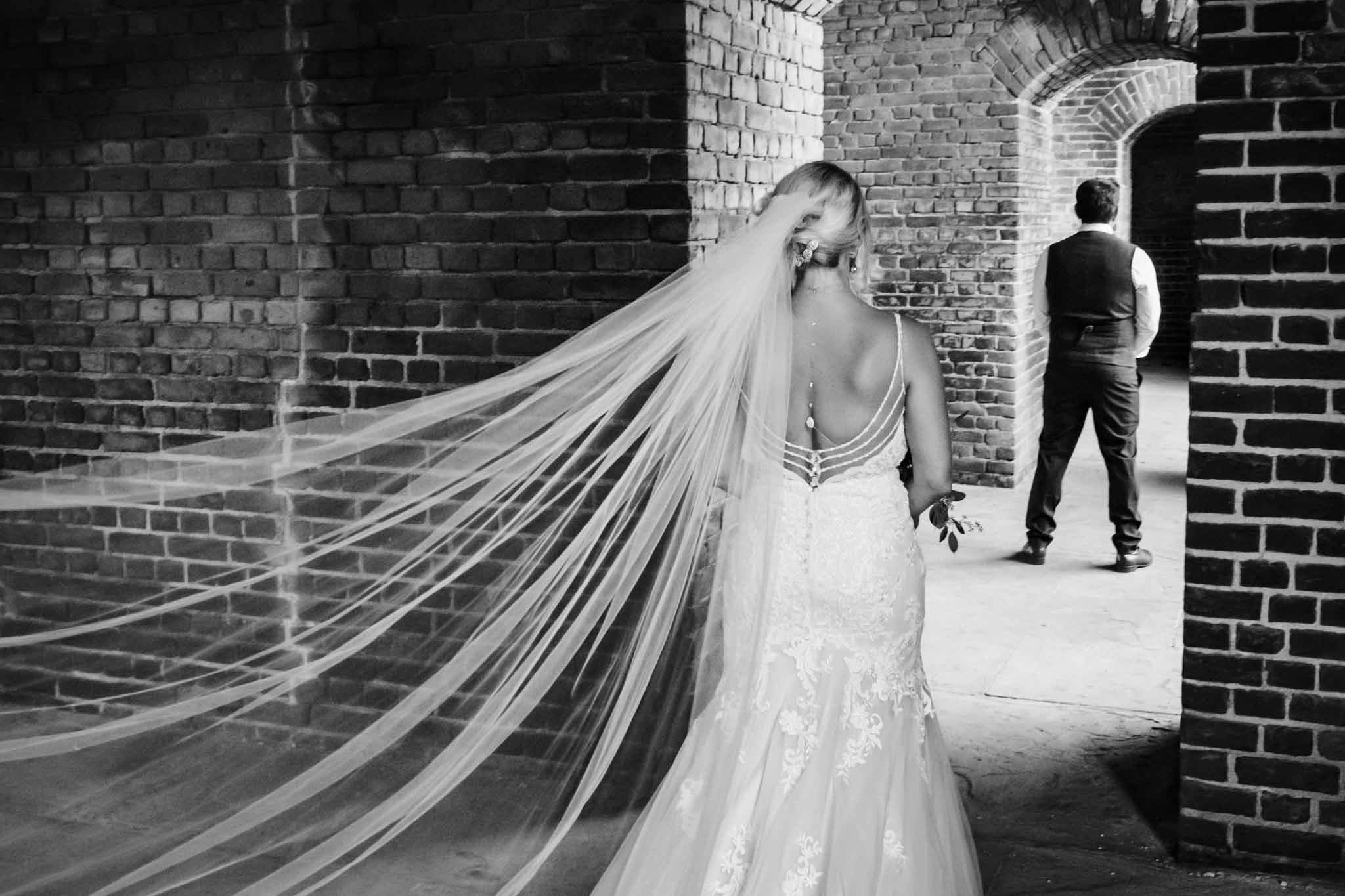 bride's veil blowing in the wind before wedding at fort zachary taylor