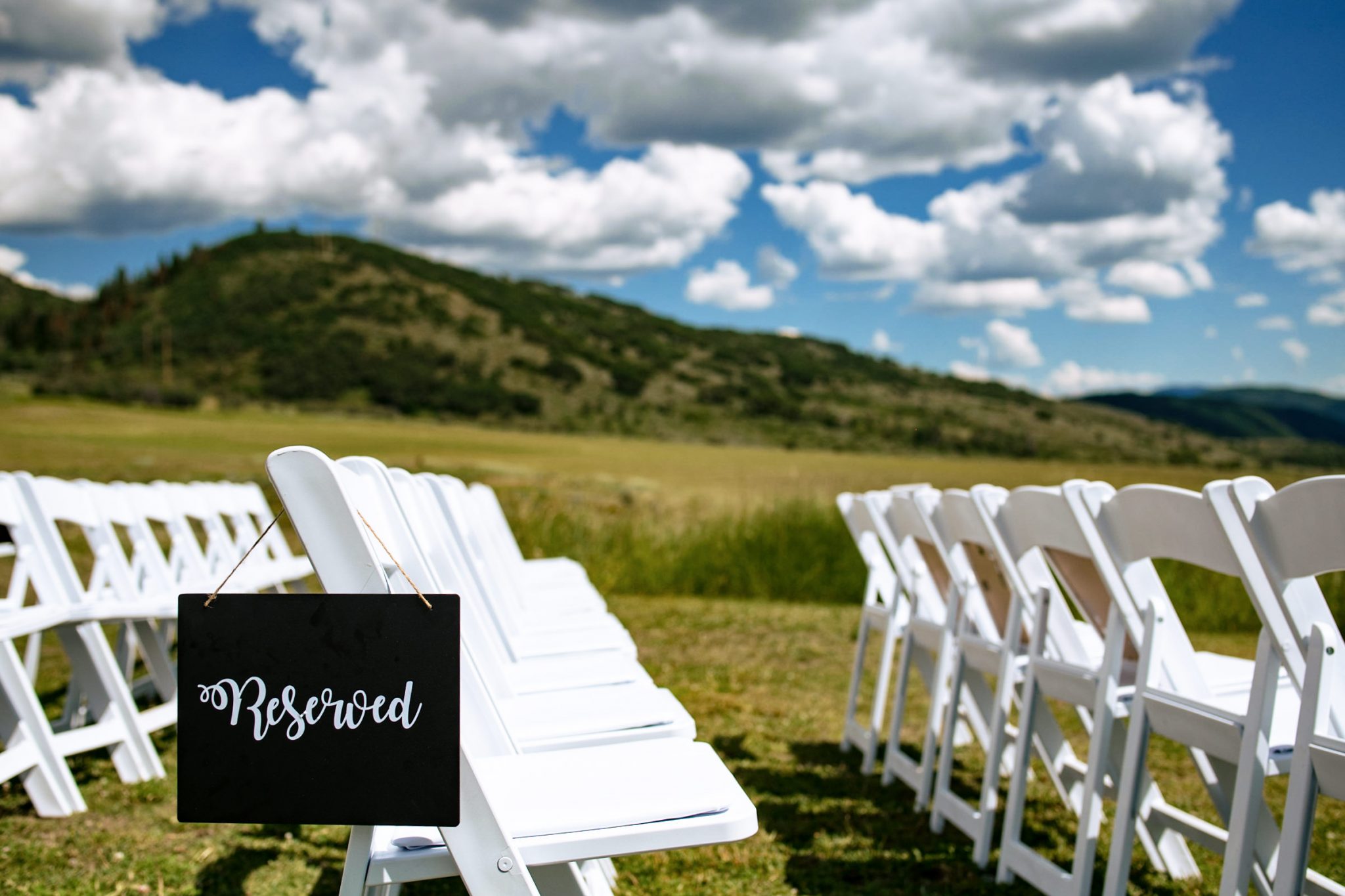 mountain wedding ceremony setup in a field