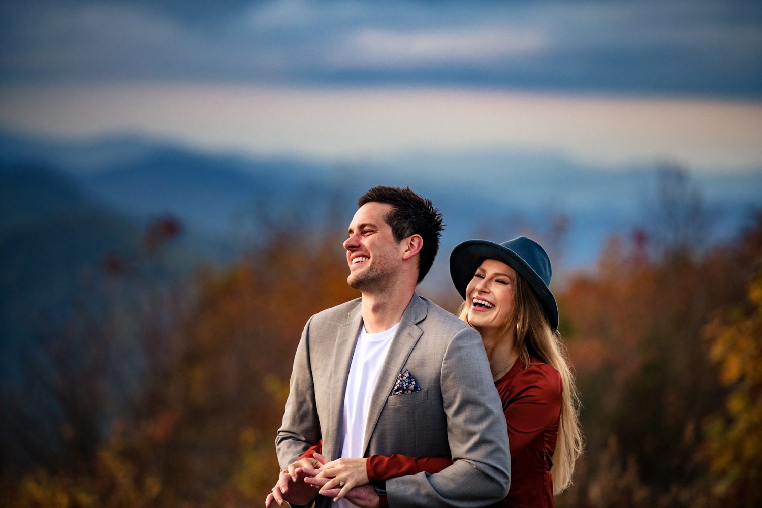 engagement couple hugging and laughing asheville engagement photos