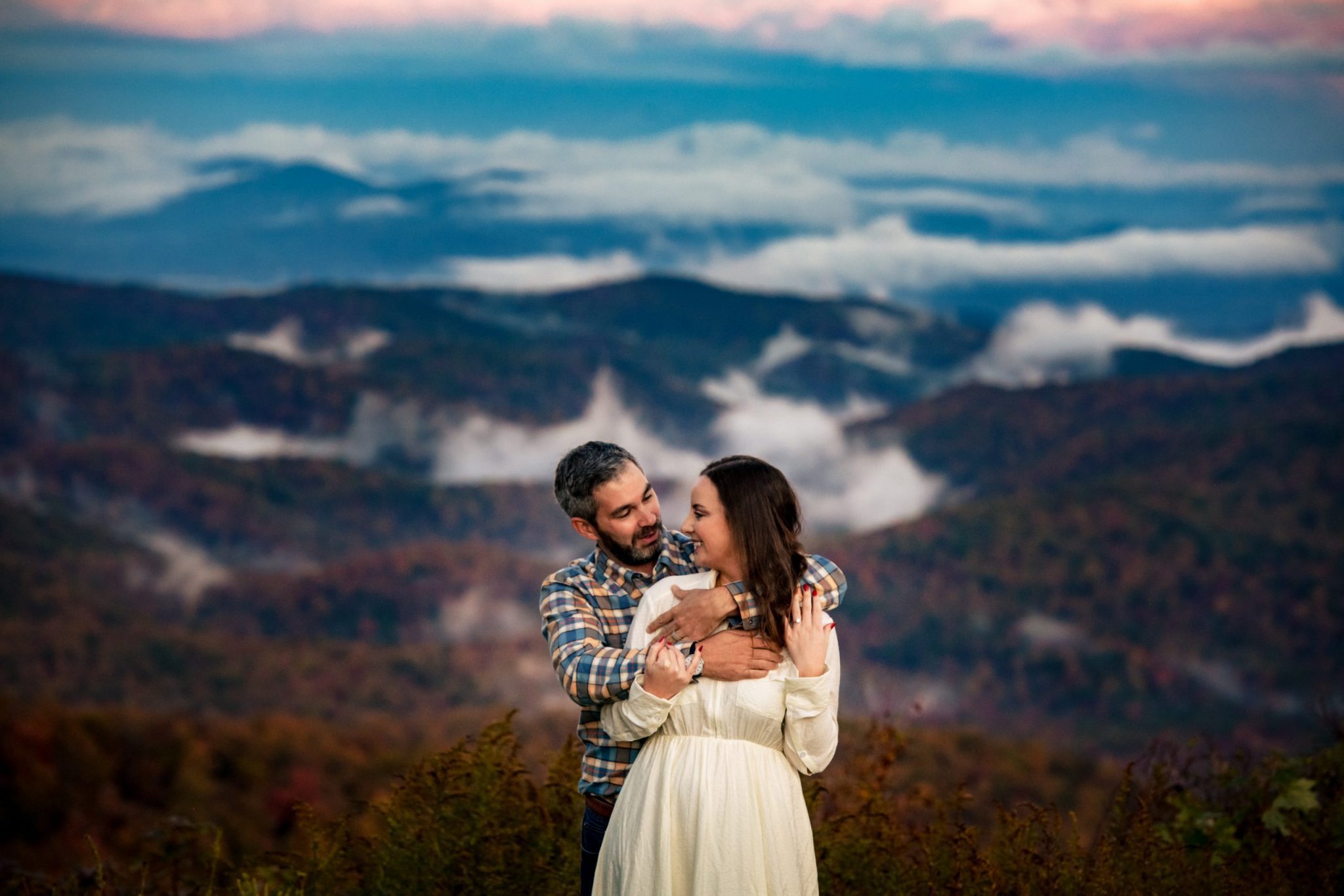 couple hugging on mountain top on the blue ridge parkway