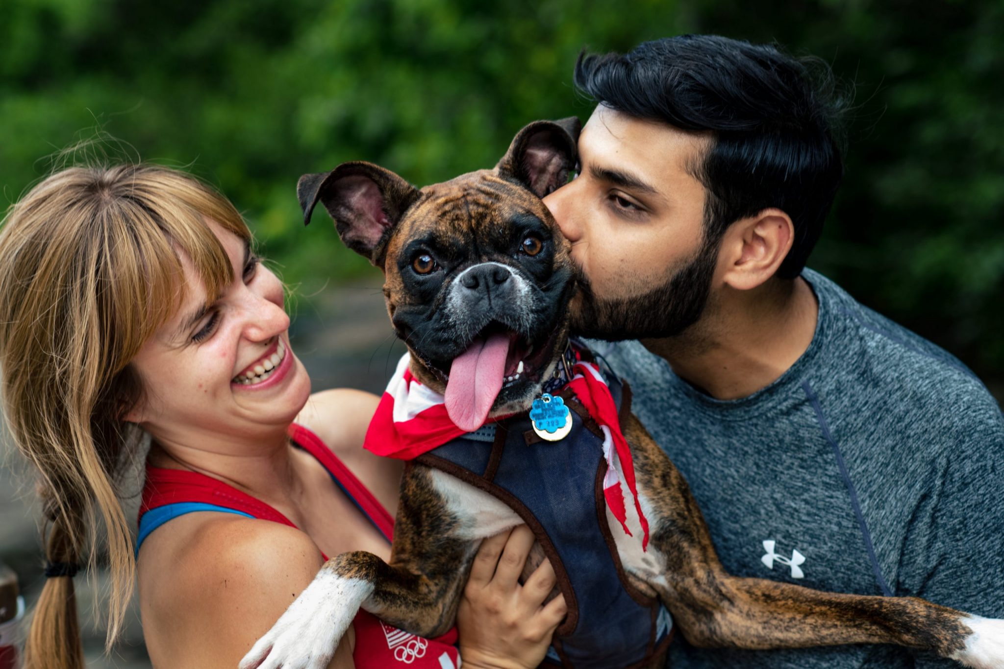 newly engaged couple kissing their dog in asheville nc