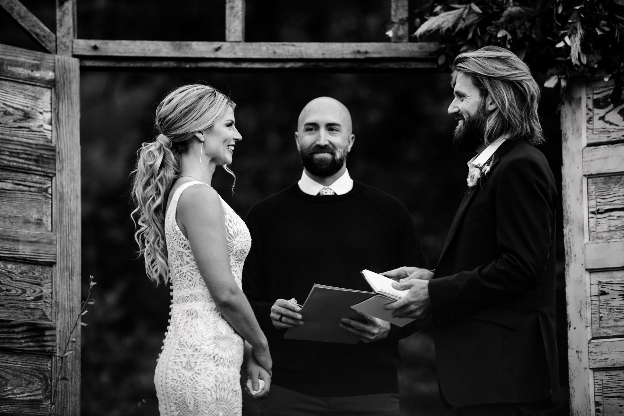 bride and groom smiling at one another during asheville wedding ceremony