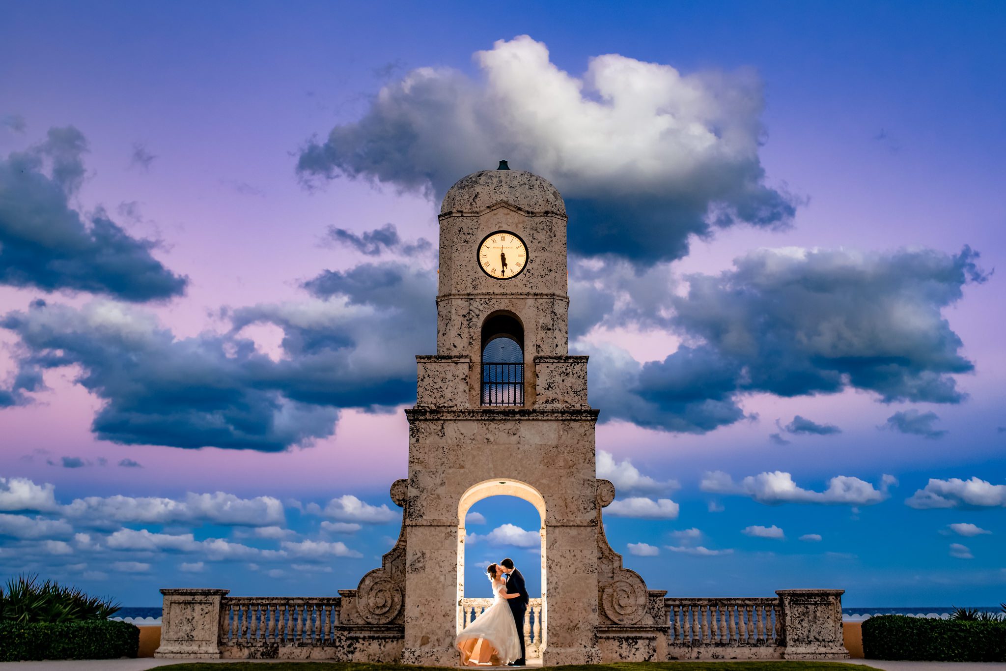 creative wedding portrait of bride and groom at clock tower in palm beach_