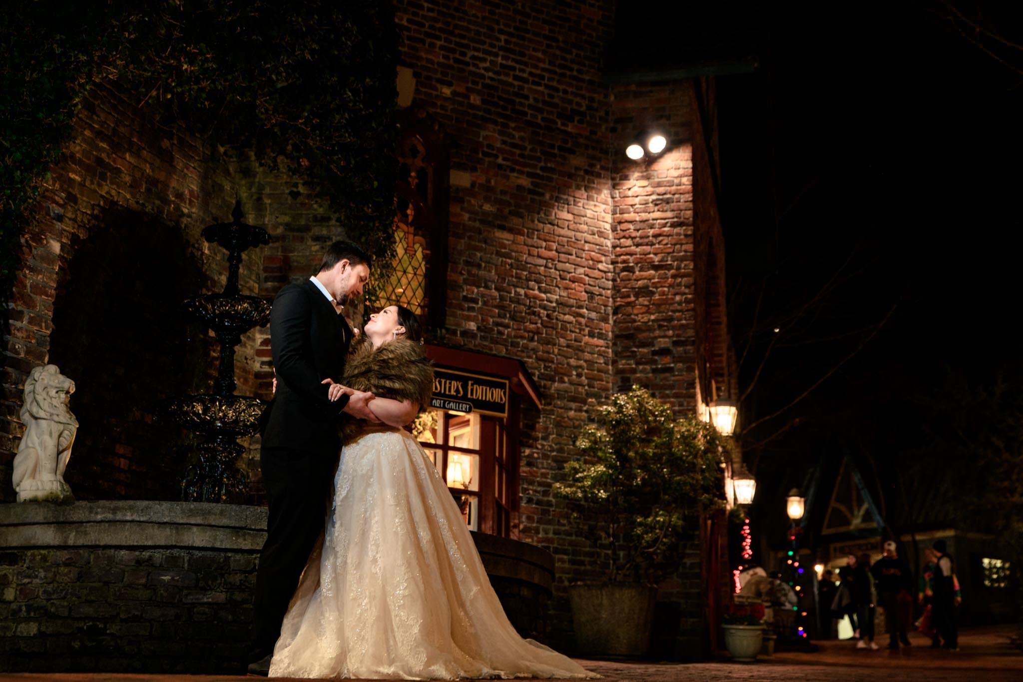 Bride and groom taking night portraits with Christmas lights in Gatlinburg Tennessee