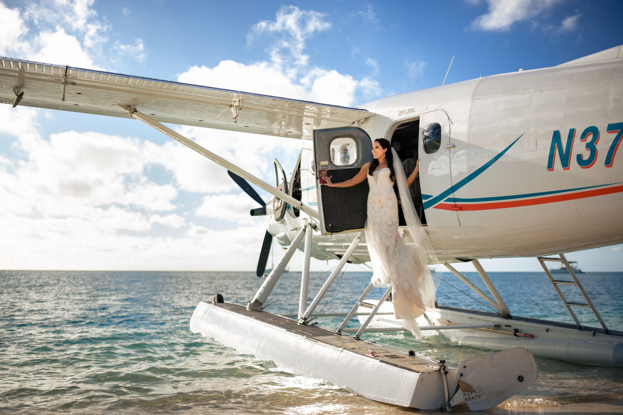 Bride stepping out of seaplane with wedding dress on at dry Tortugas national Park