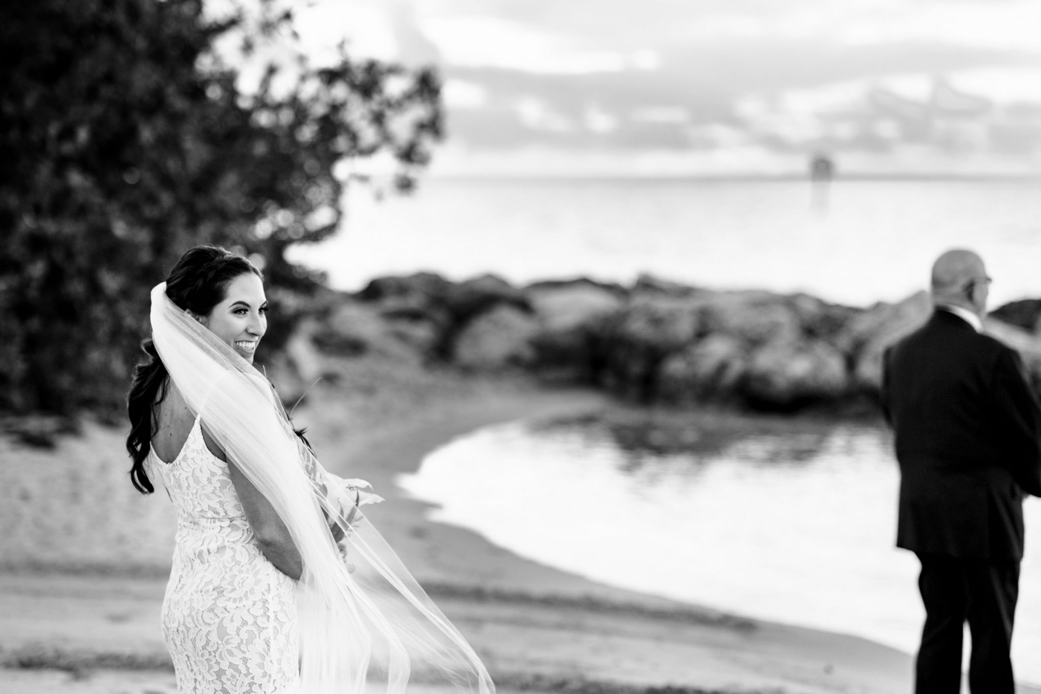Bride smiling and laughing during first look on Smathers Beach in Key West Florida