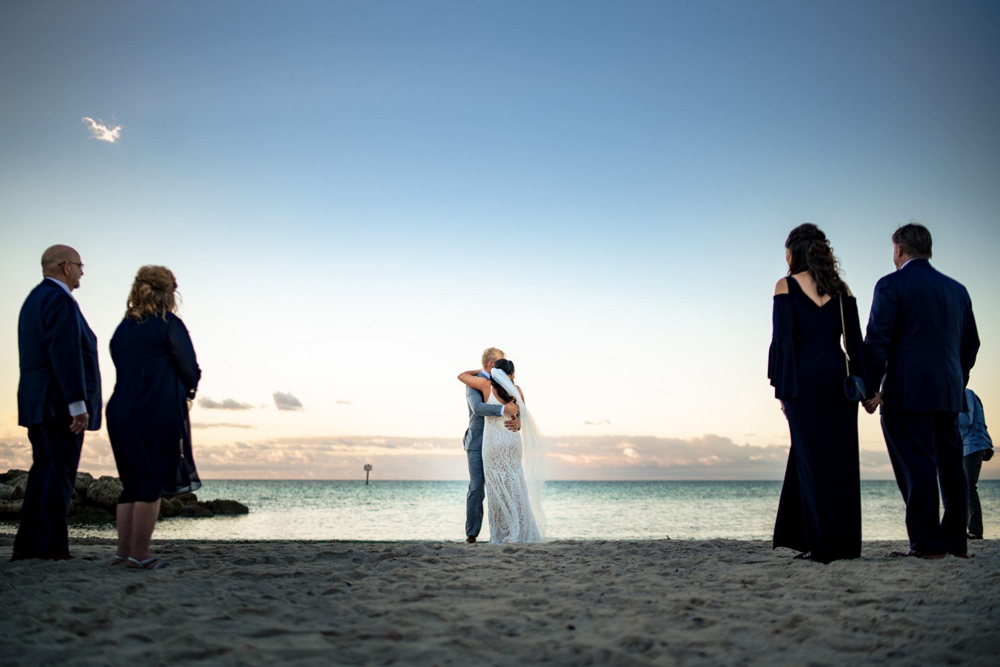 Bride and groom embracing during first look on Smathers Beach in Key West Florida at sunrise