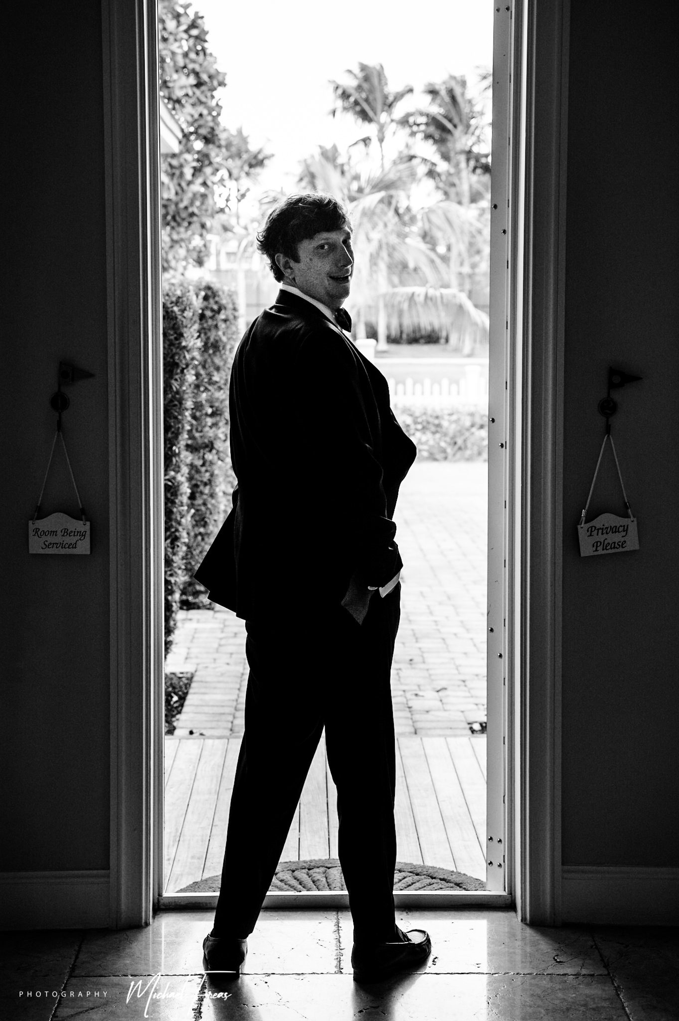 A man in a tuxedo standing in a Florida Keys doorway.