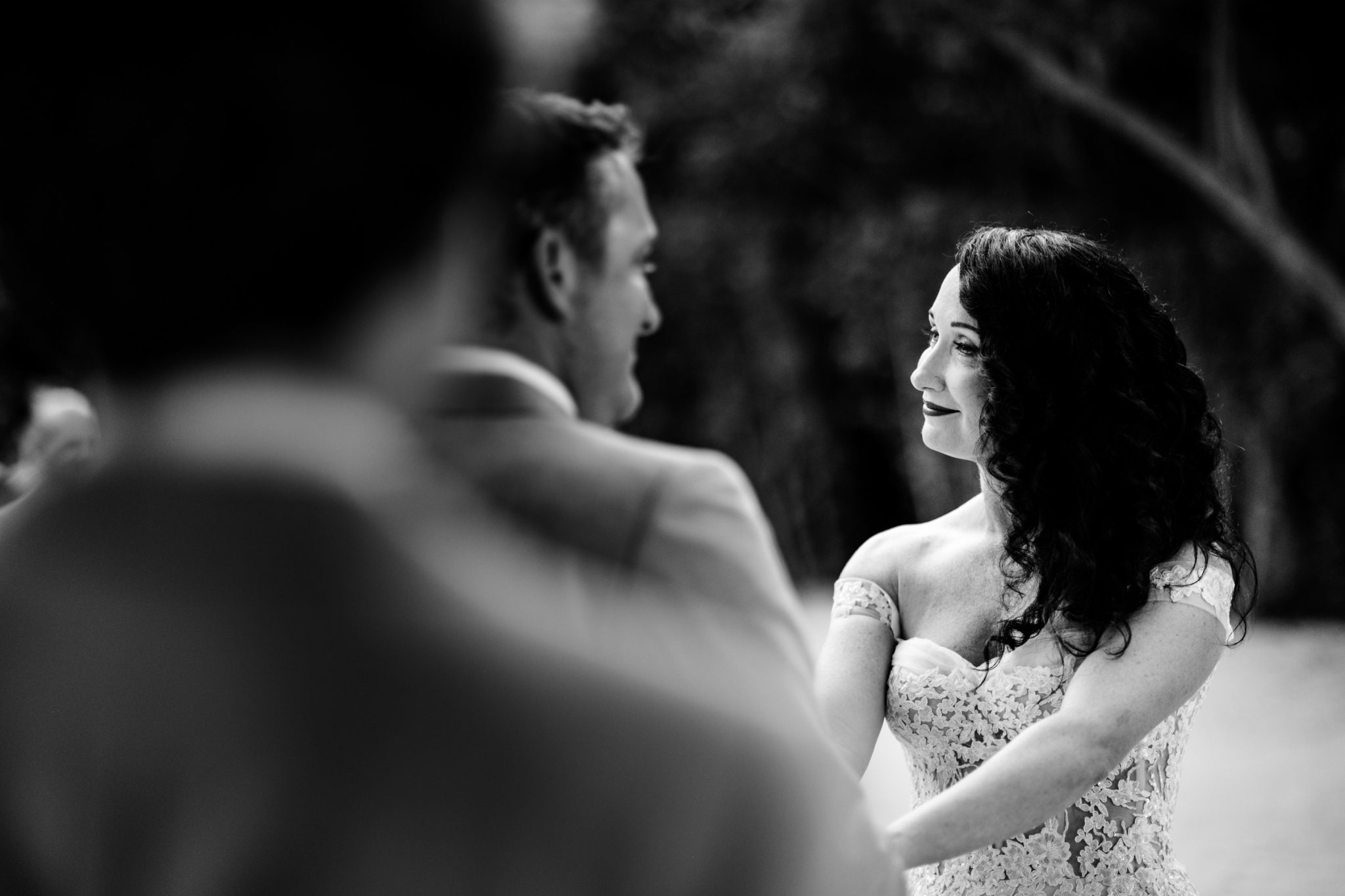 bride smiling as he sees bride for the first time under flower arch at bakers cay resort