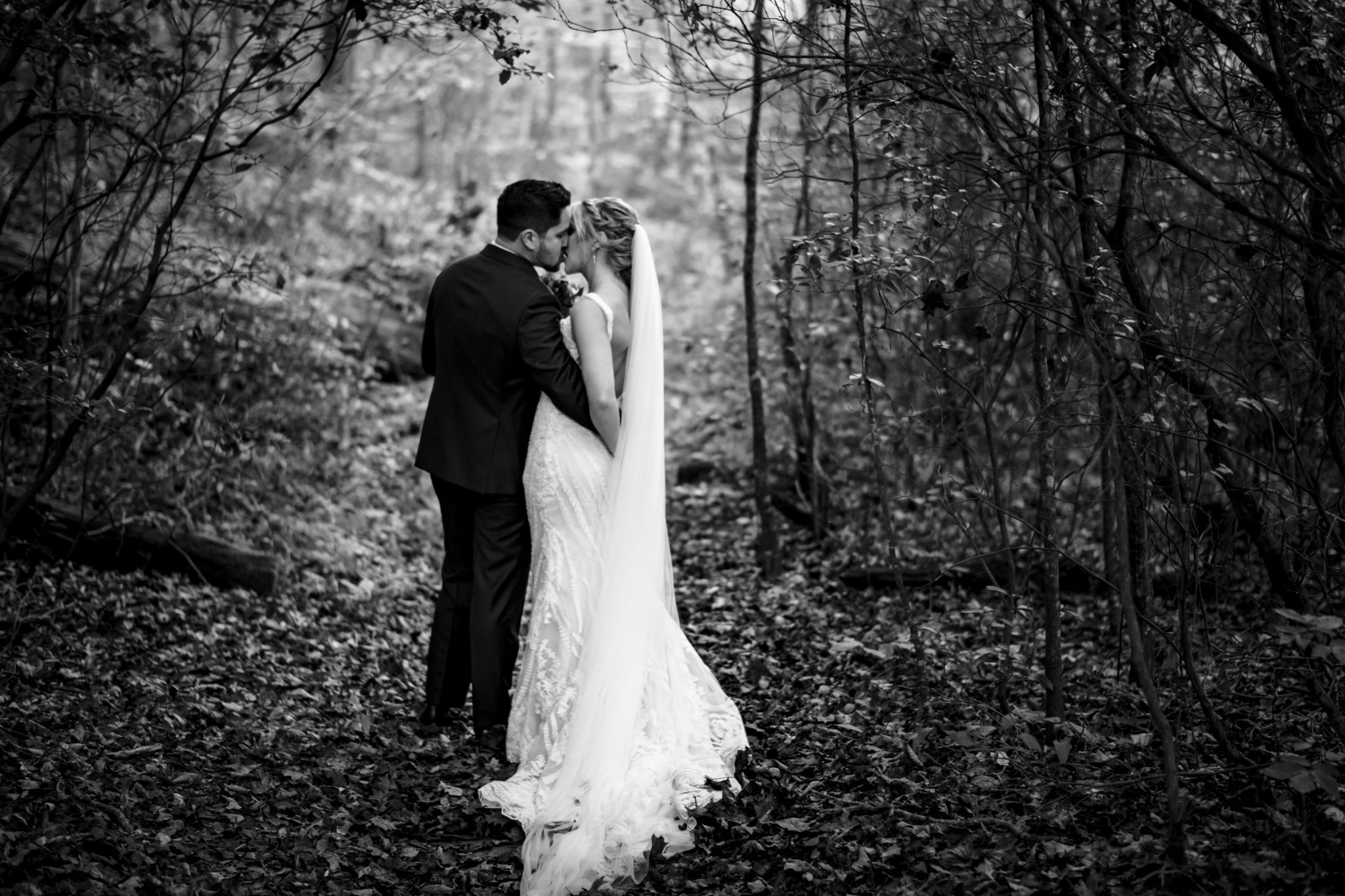Bride and groom kissing in the woods at Prince William Forest Park