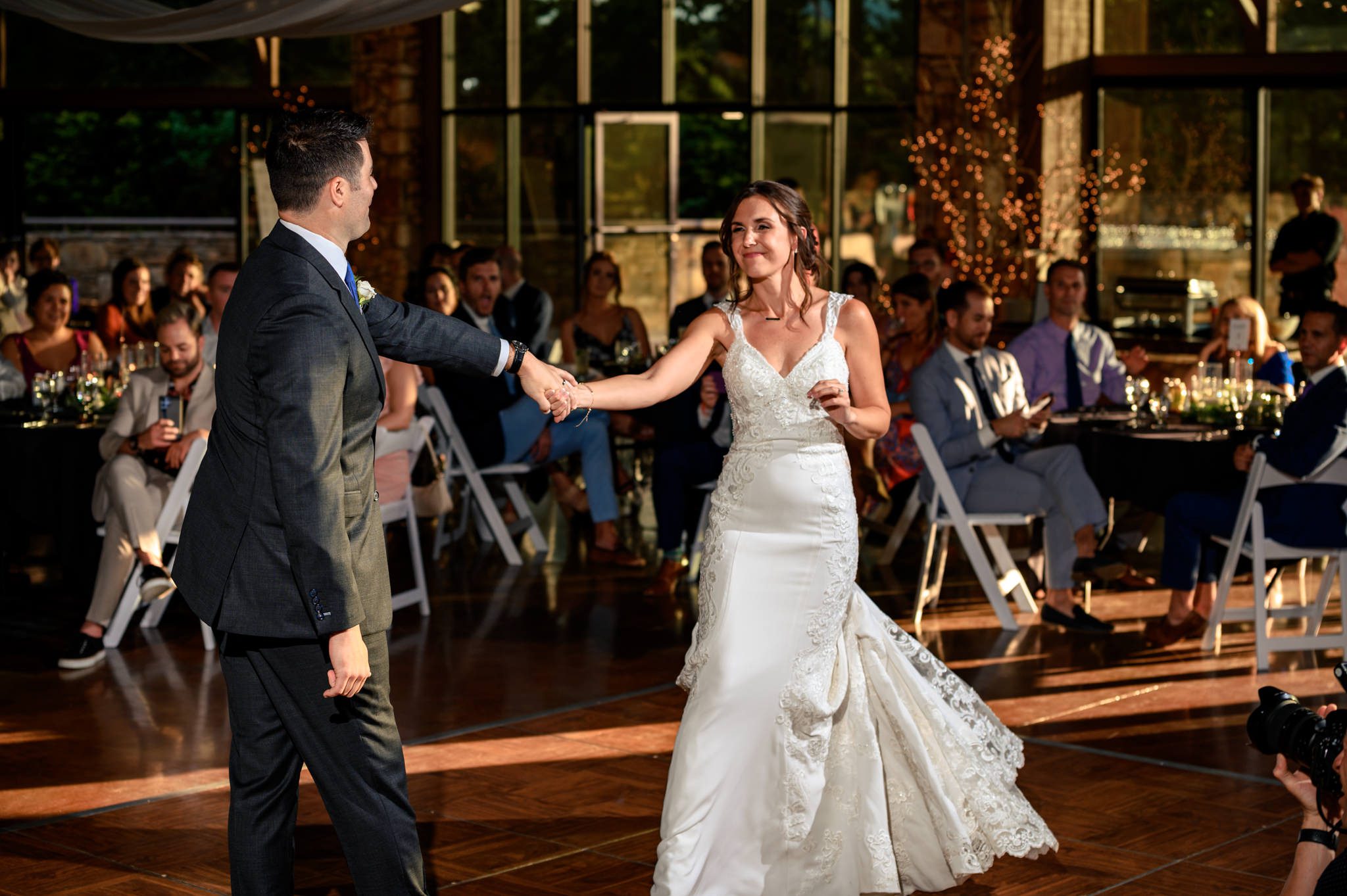 A bride and groom elegantly share their first dance at a wedding reception captured by a documentary wedding photographer at the Crest Pavilion.
