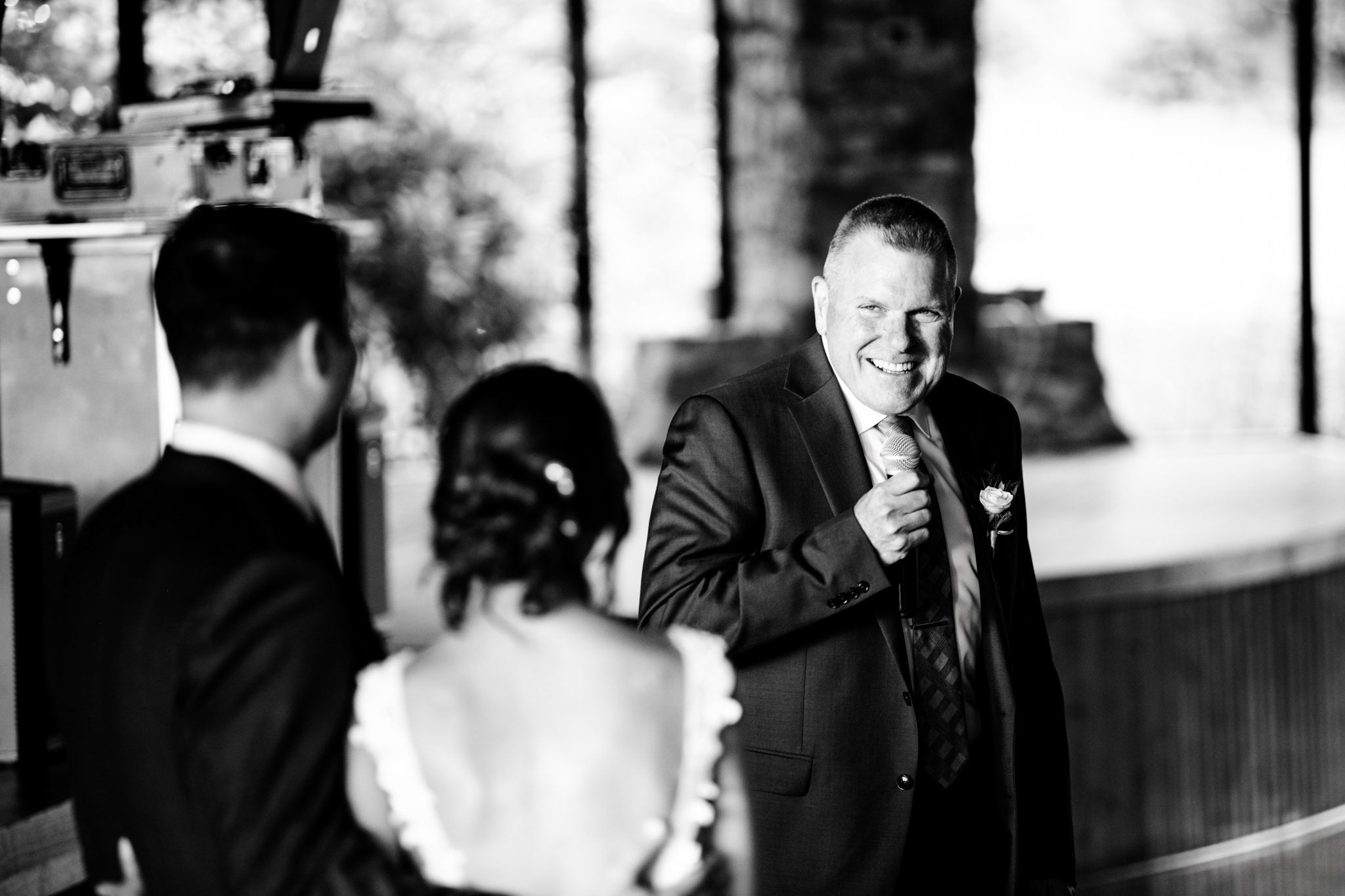 A documentary wedding photographer capturing a man in a suit at Crest Pavilion.
