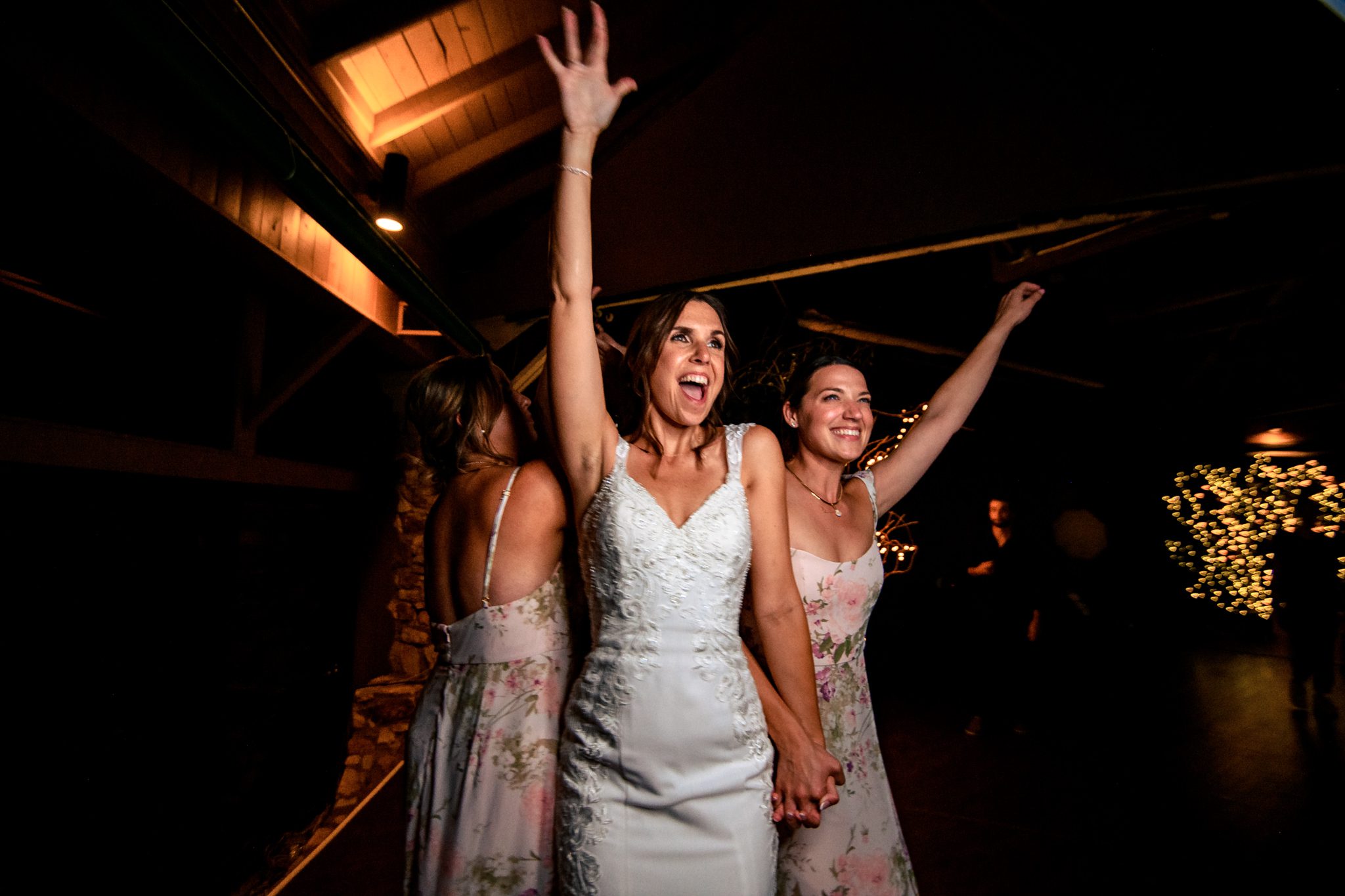 Two bridesmaids dancing on the dance floor at night at the crest pavilion.