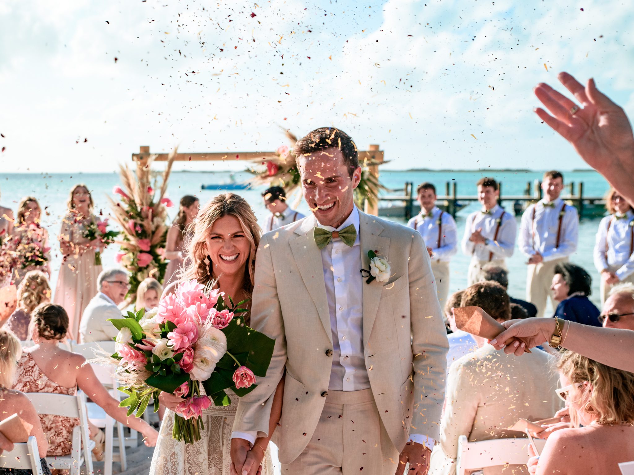 bride and groom exiting wedding ceremony at playa largo resort with flower confetti being thrown