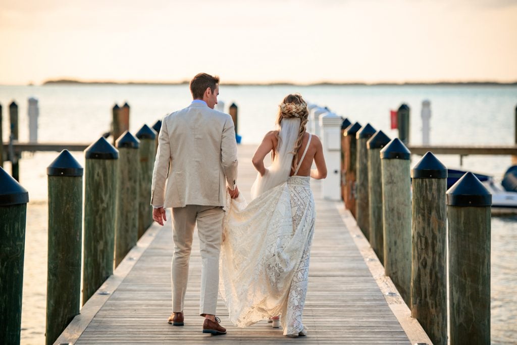 bride and groom walking on dock