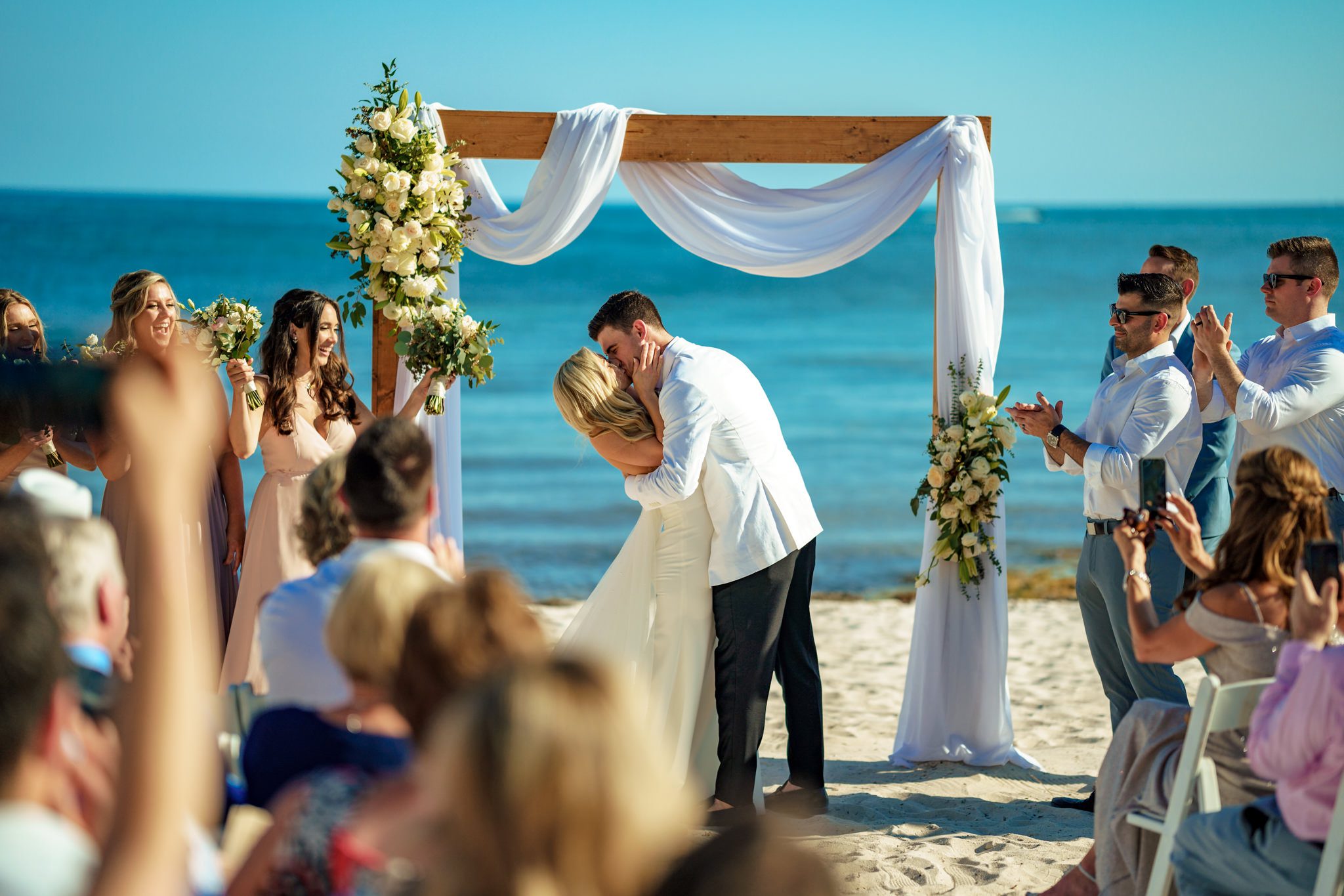 A bride and groom have a romantic beach kiss during their Casa Marina Key West wedding.