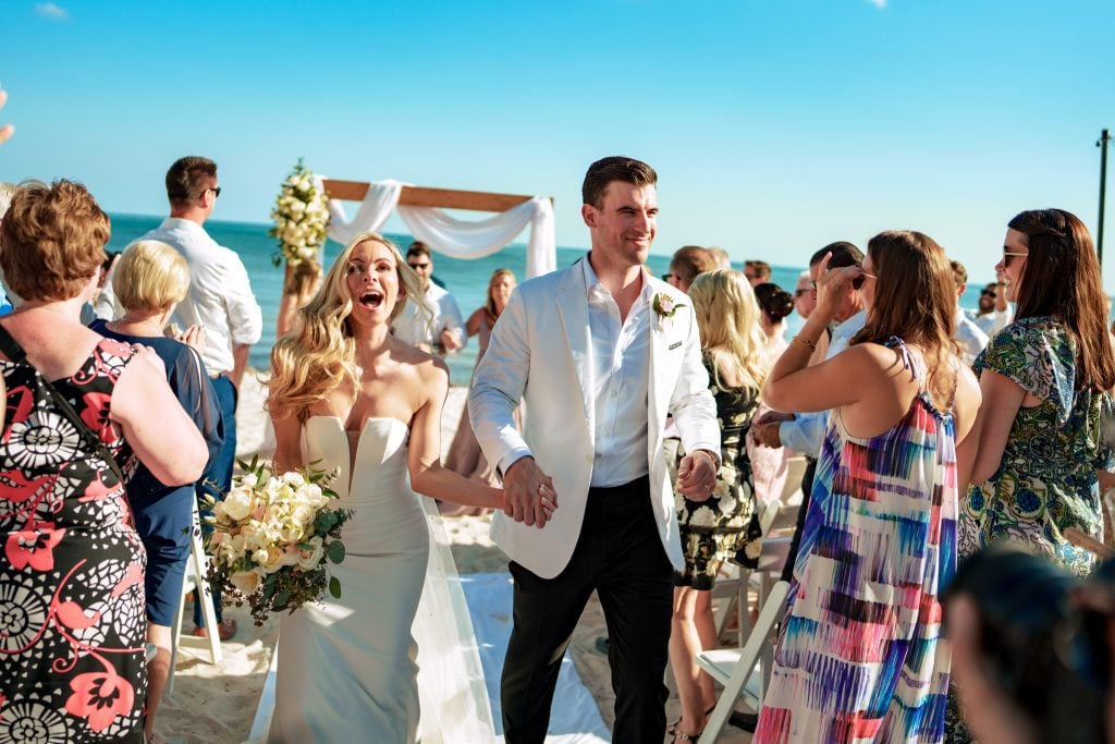 A bride and groom have a beautiful Casa Marina Key West wedding on the beach.