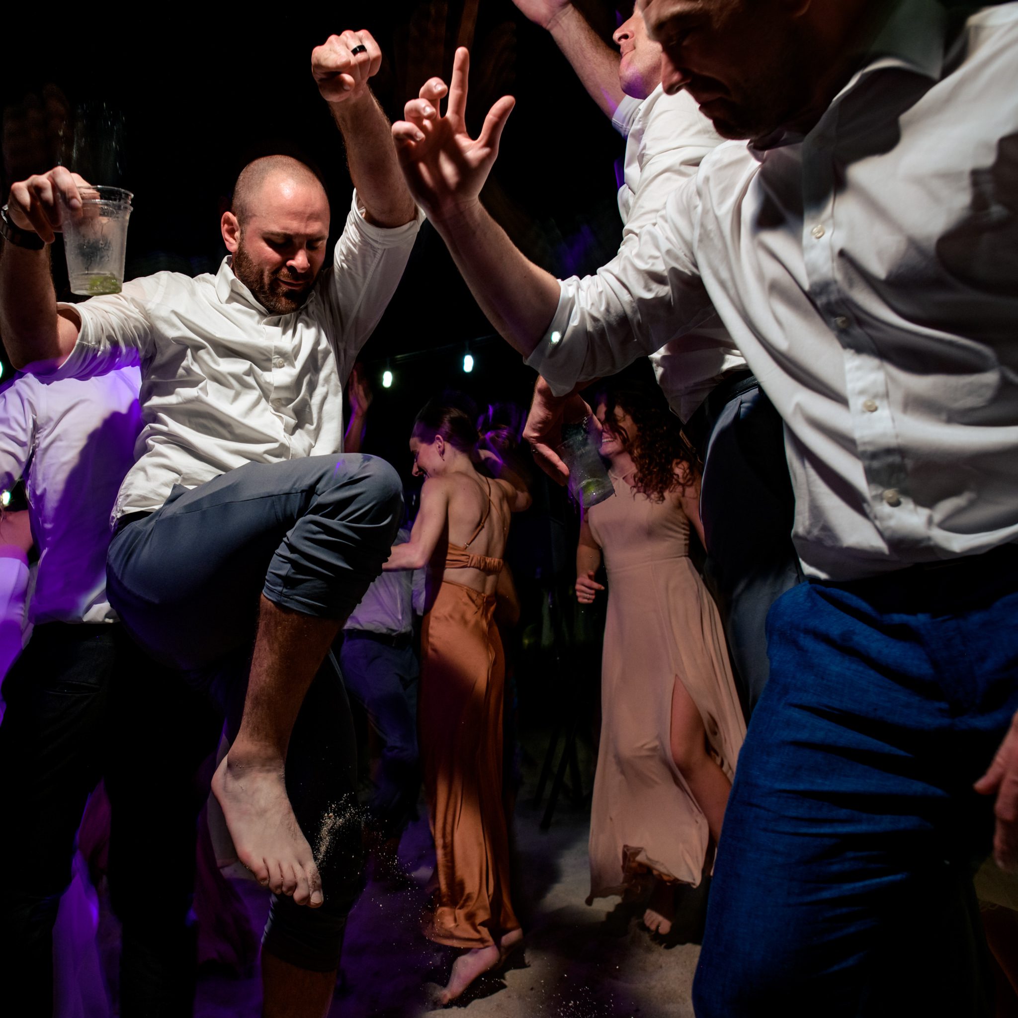 A group of men dancing at a Casa Marina Key West wedding party.