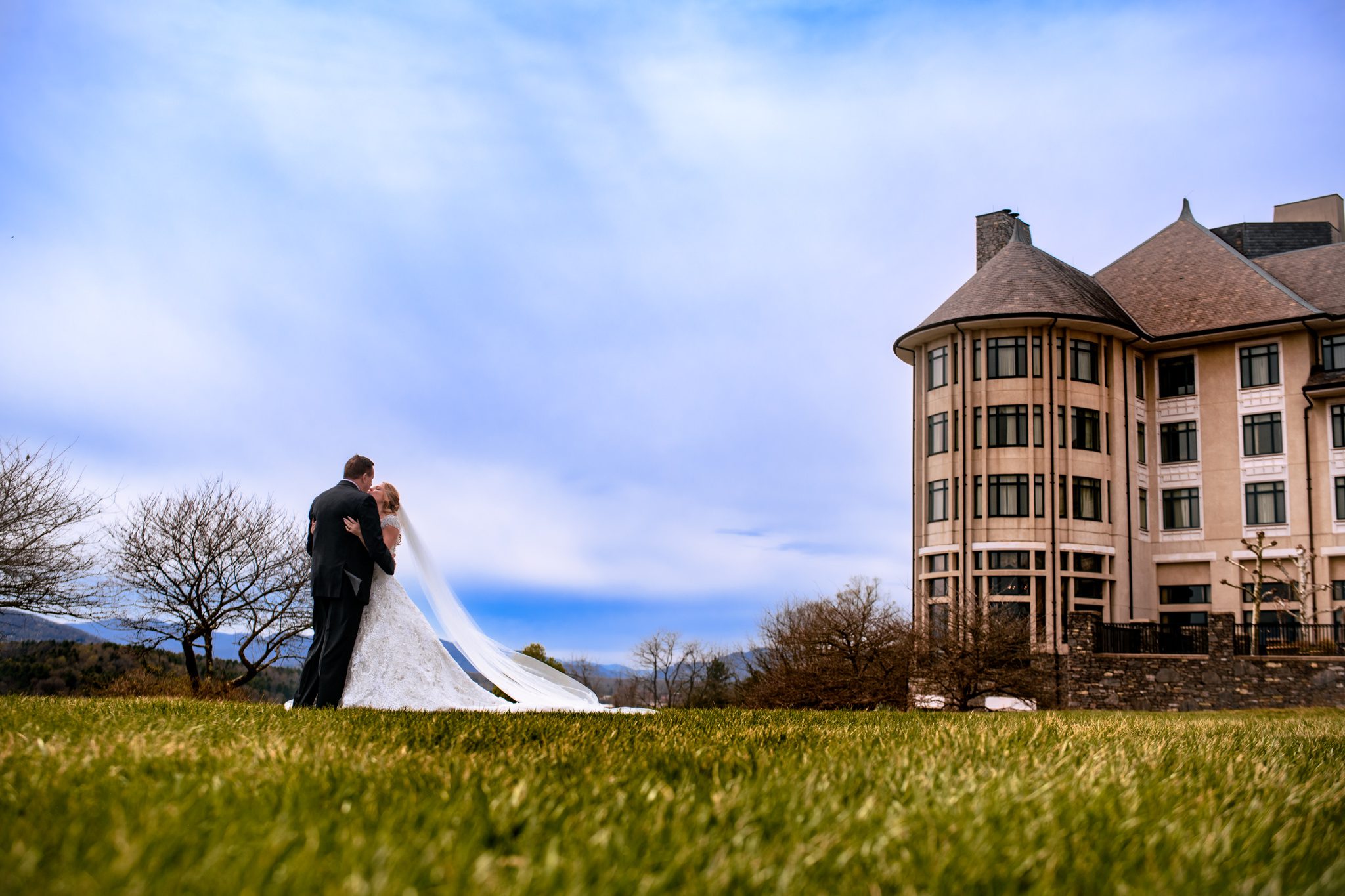 wedding couple kissing on sunset lawn of the inn at biltmore