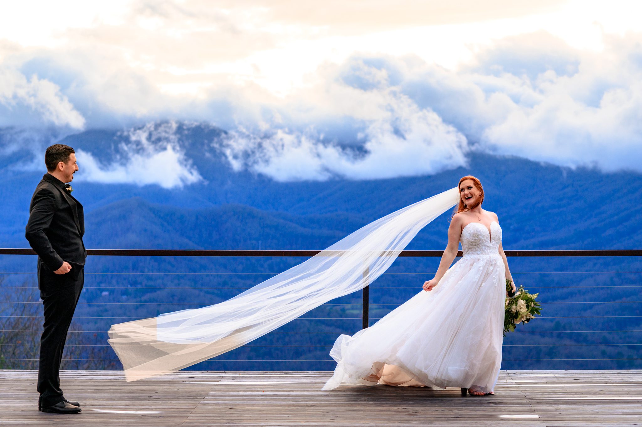wind takes a brides veil and blows it across the deck towards her groom at the parker mill
