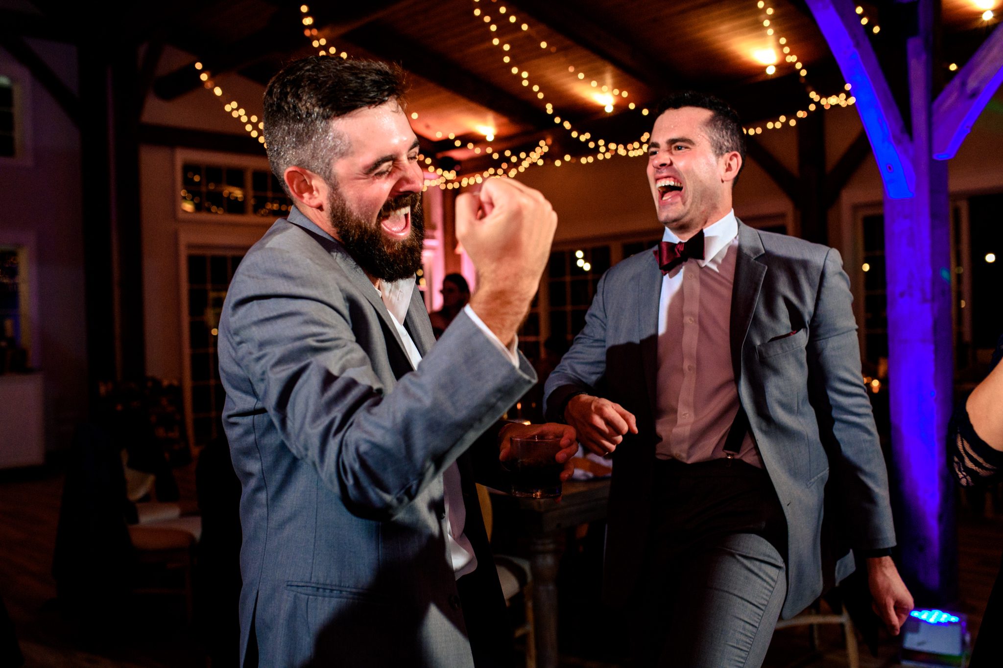 2 groomsmen dancing together