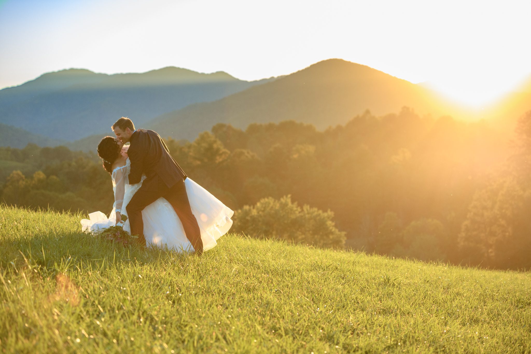 wedding couple taking sunset photos at a wedding at the ridge asheville nc