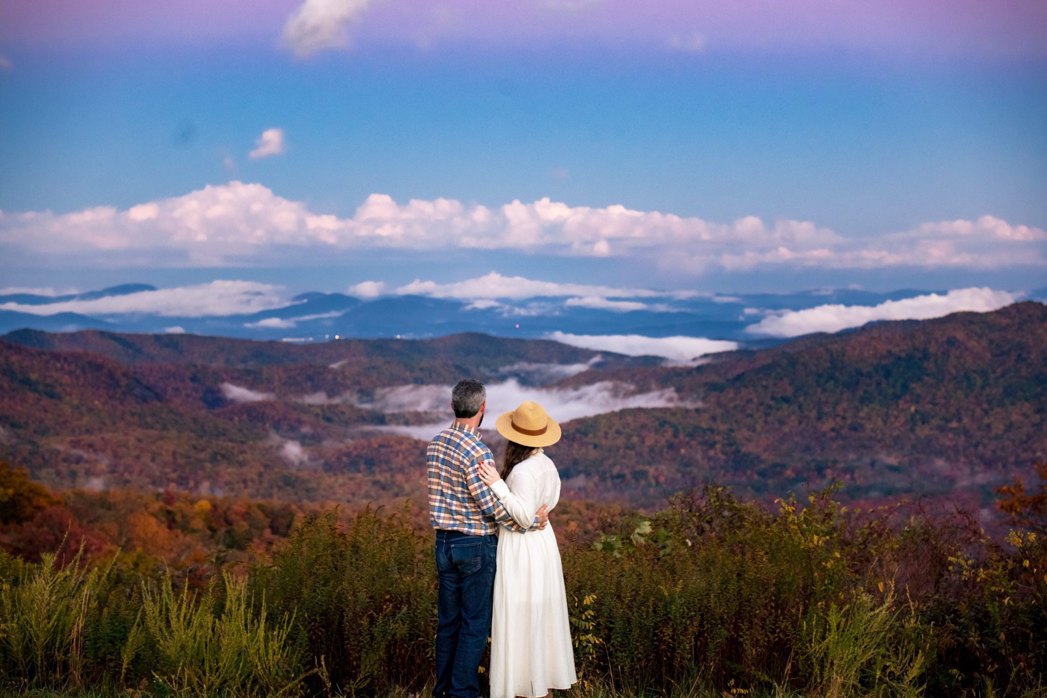 couple standing on mountain top in asheville nc