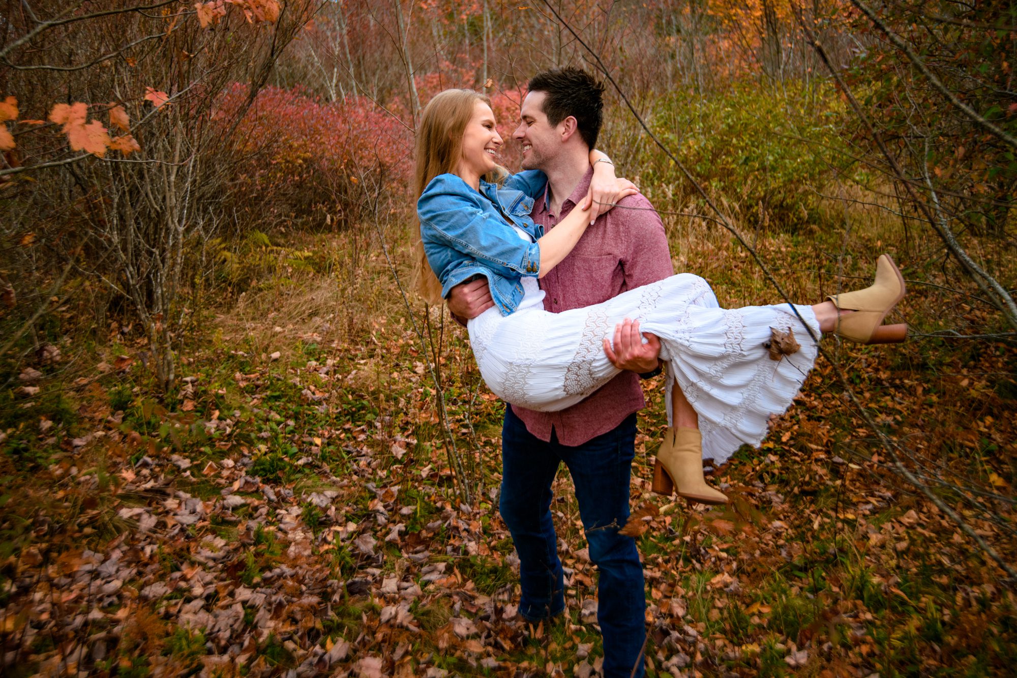 newly engaged couple hiking in fall colors at graveyard fields
