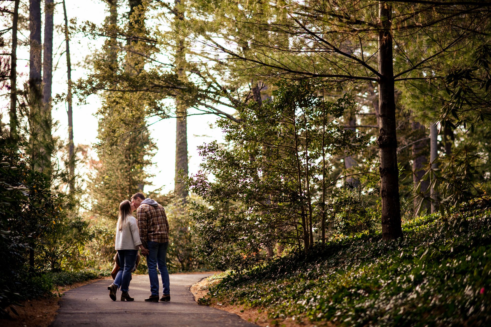 newly engaged couple taking engagement photos at biltmore estate during the fall