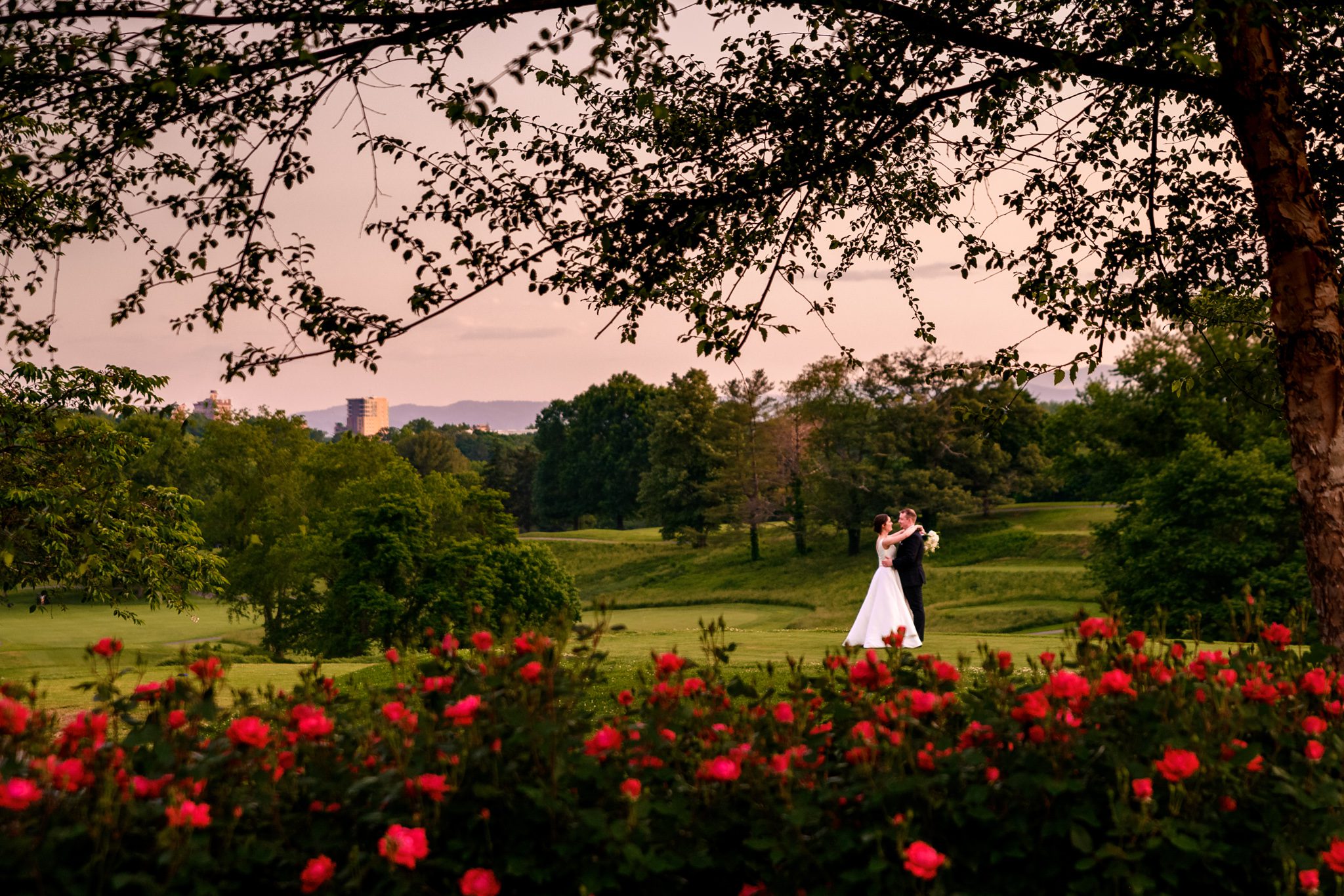 bride and groom taking sunset wedding photos on the fairway of grove park inn country club