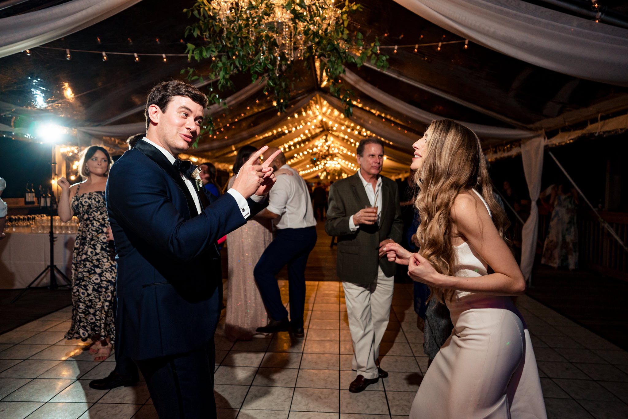 Bride and groom, dancing, and singing together, while Velvet City Sound Band plays in the background at Ocean Key resort wedding