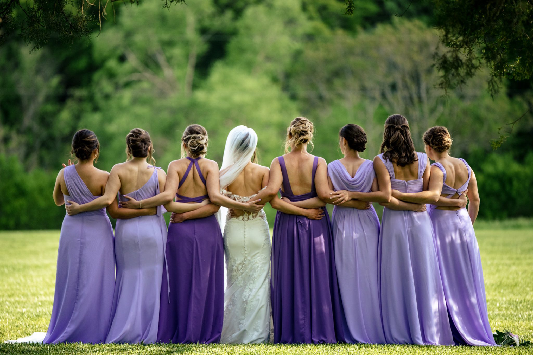 bridemaids showing the backs of their dresses