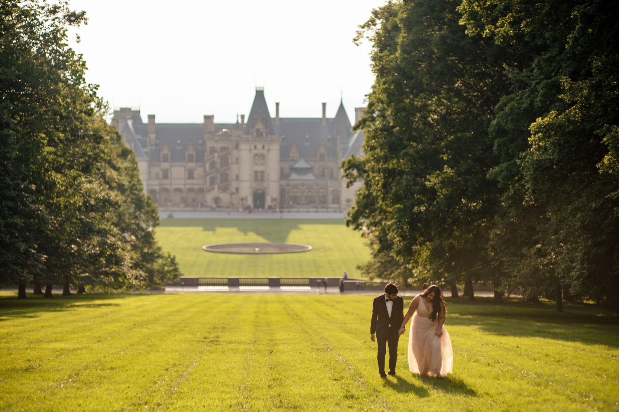 engaged couple taking engagement photos at biltmore estate in asheville nc