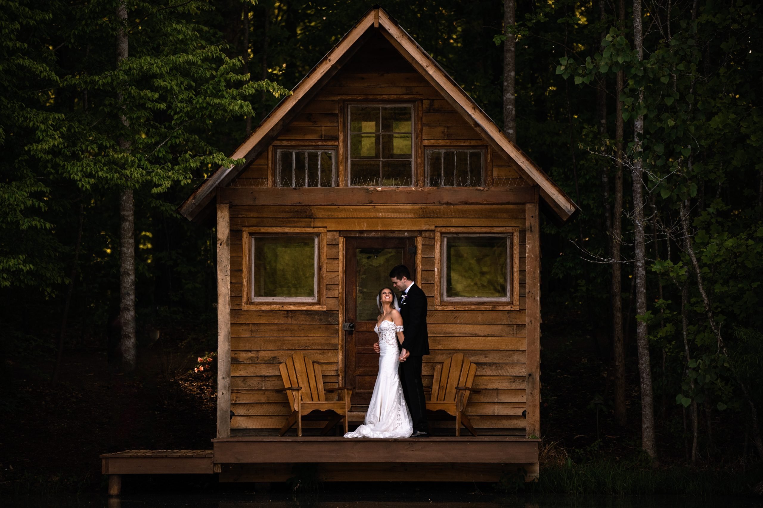 wedding couple embrace on the duck pond fishing cabin at kinslesshop farm