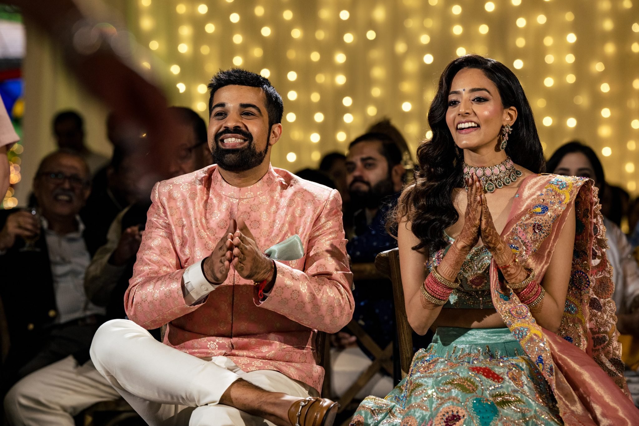 An Indian couple clapping at their Biltmore Estate wedding reception.