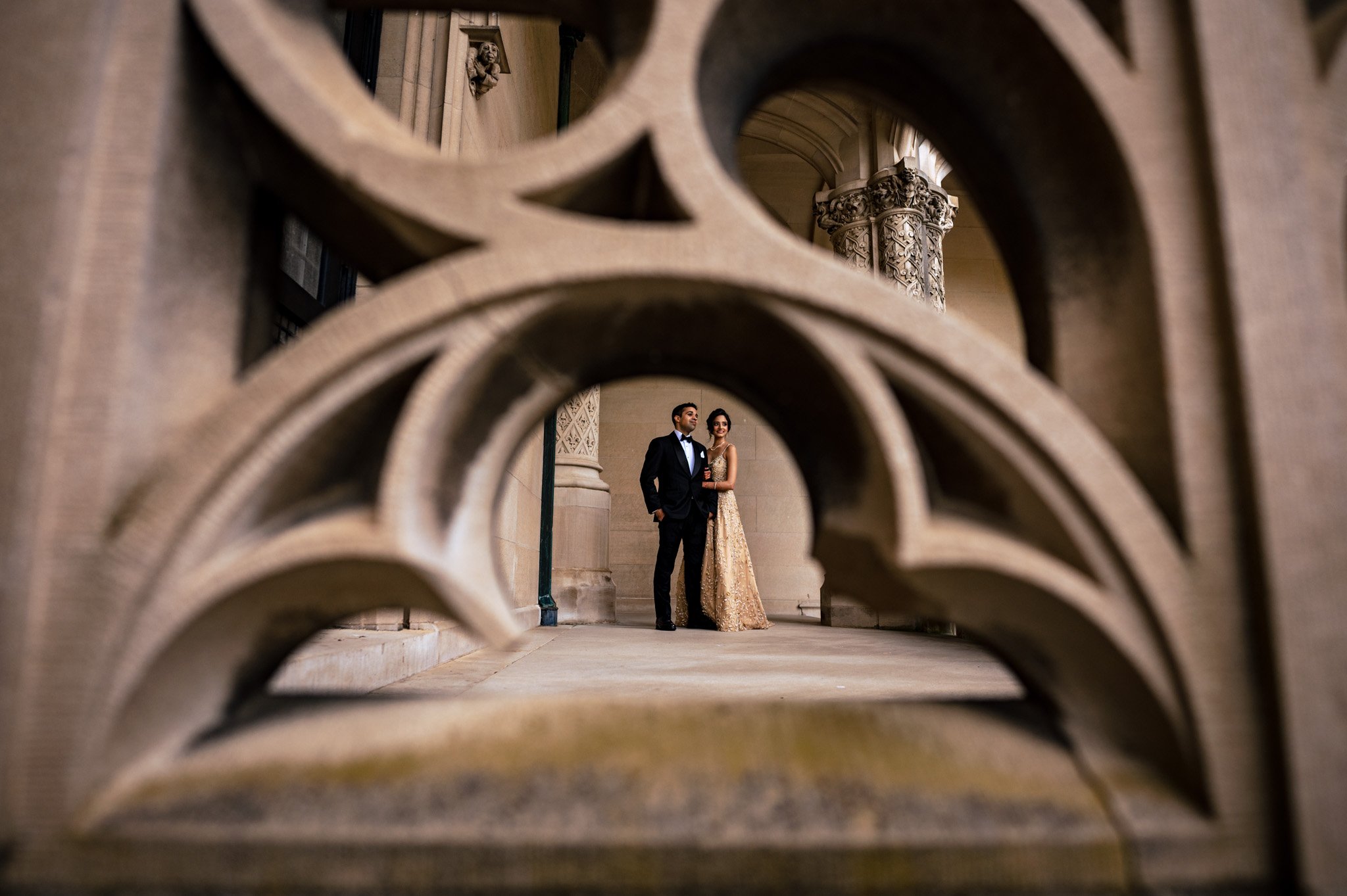 A bride and groom standing in the archway of the Biltmore Estate.