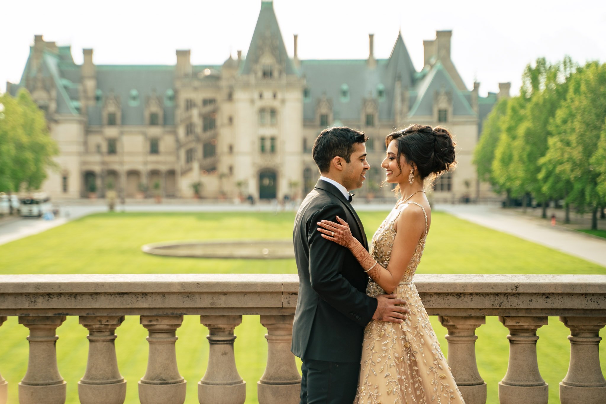 A couple poses for a wedding photo at Biltmore Estate.
