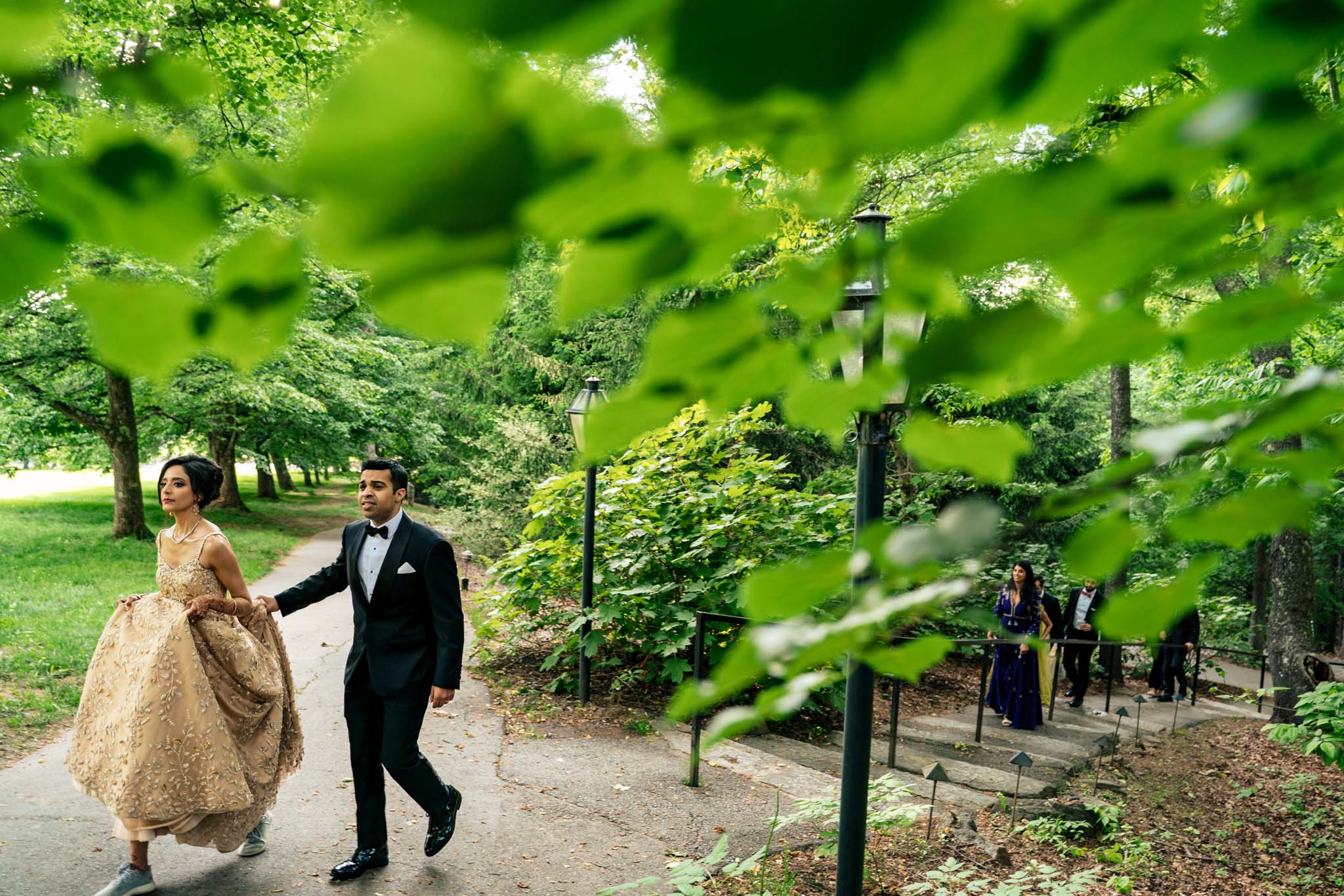 A bride and groom walking down a path at a Biltmore Estate wedding.