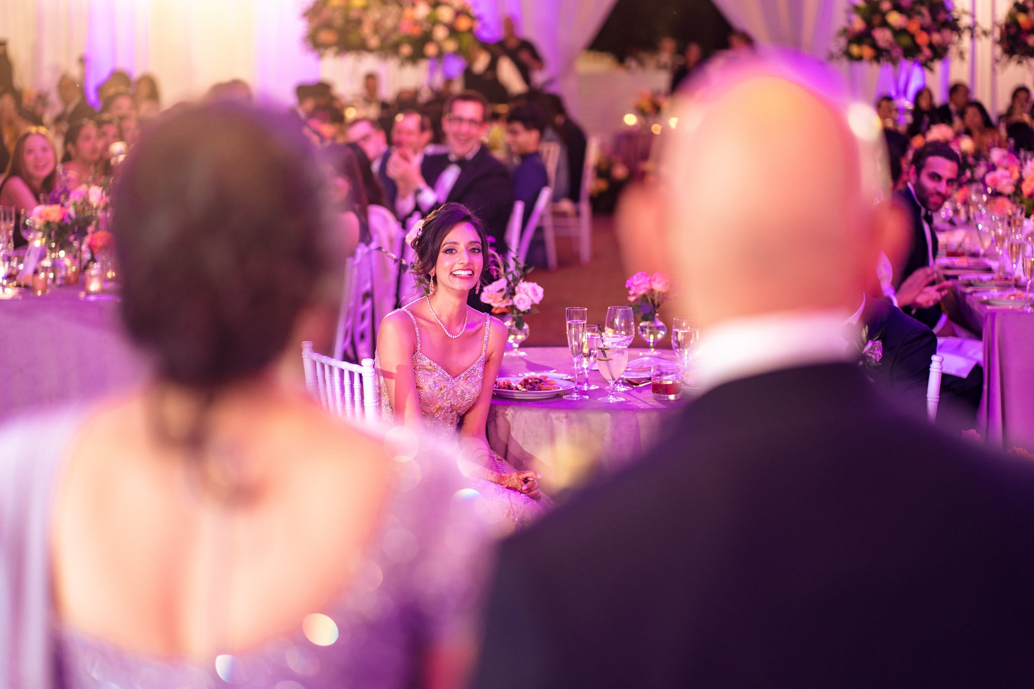 A bride and groom exchanging glances at a Biltmore Estate wedding reception.