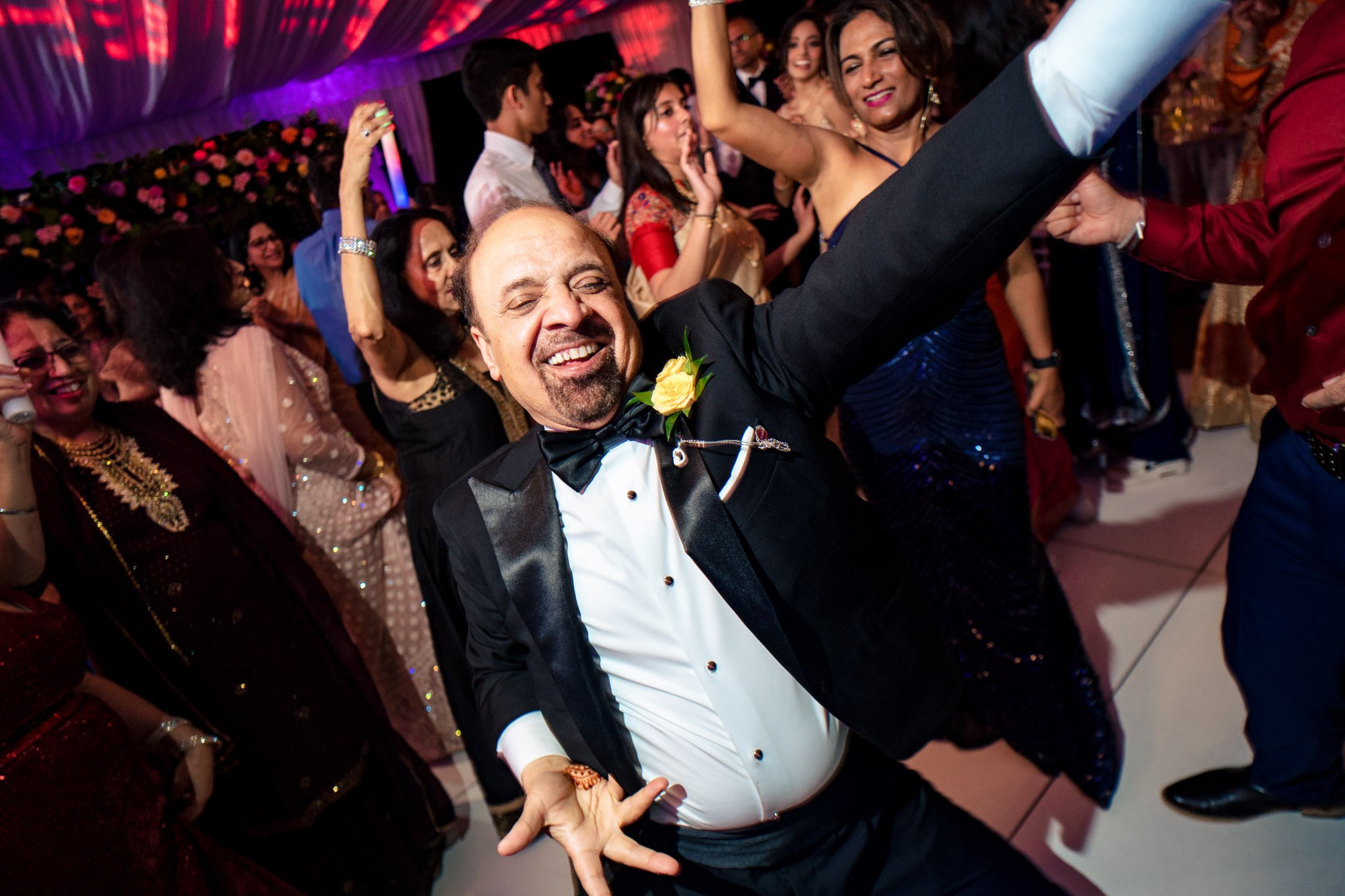 A man in a tuxedo dancing at a Biltmore Estate wedding reception.