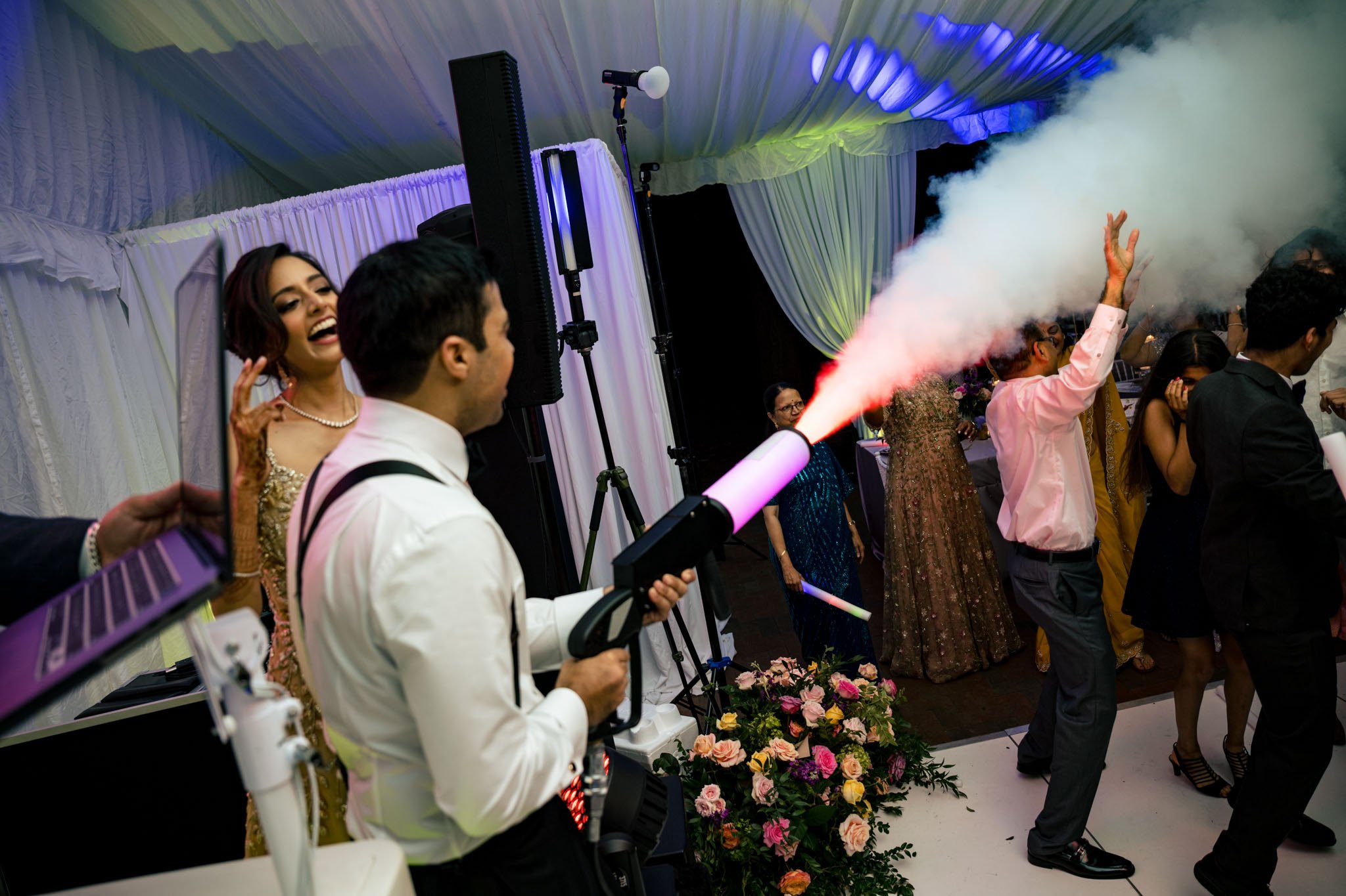 A man blowing smoke at a Biltmore Estate wedding reception.