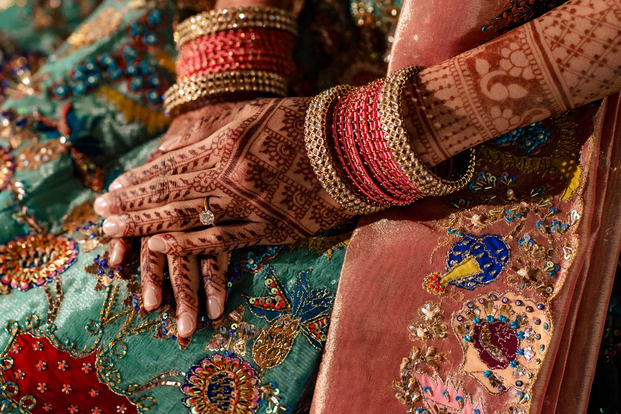 An Indian bride's hands are decorated with henna at a Biltmore Estate wedding.