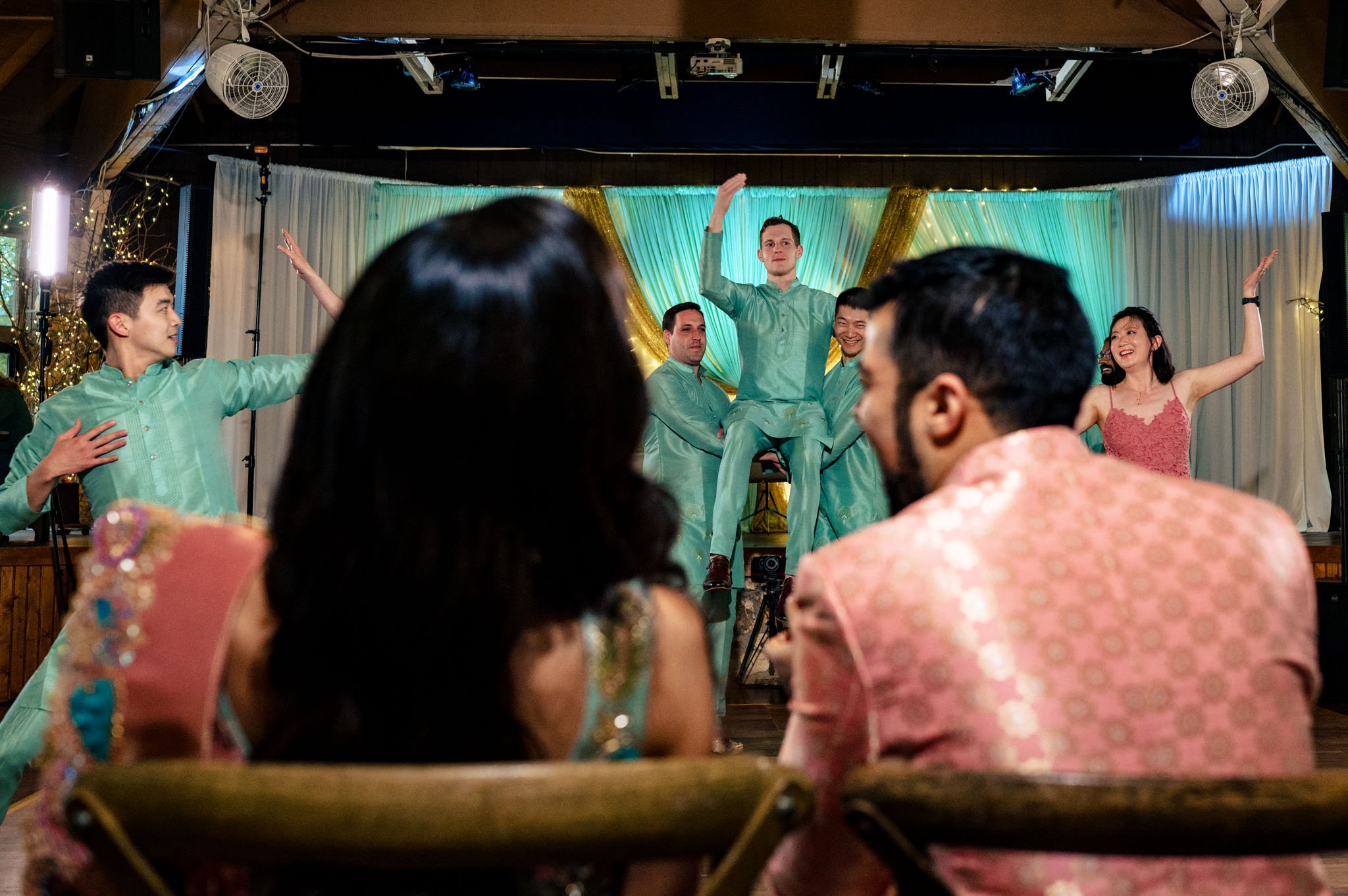 A group of people performing a dance at an Indian wedding held at the Biltmore Estate.