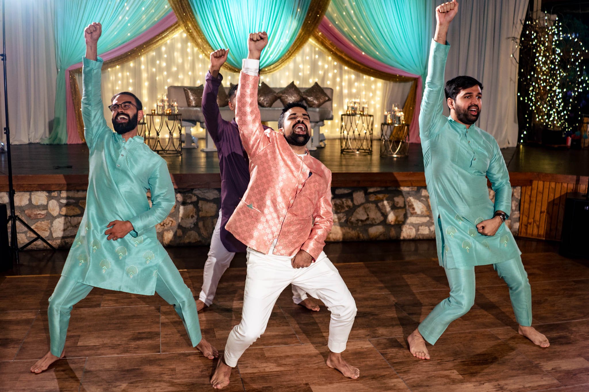 A group of Indian men dancing at a wedding reception at Biltmore Estate.