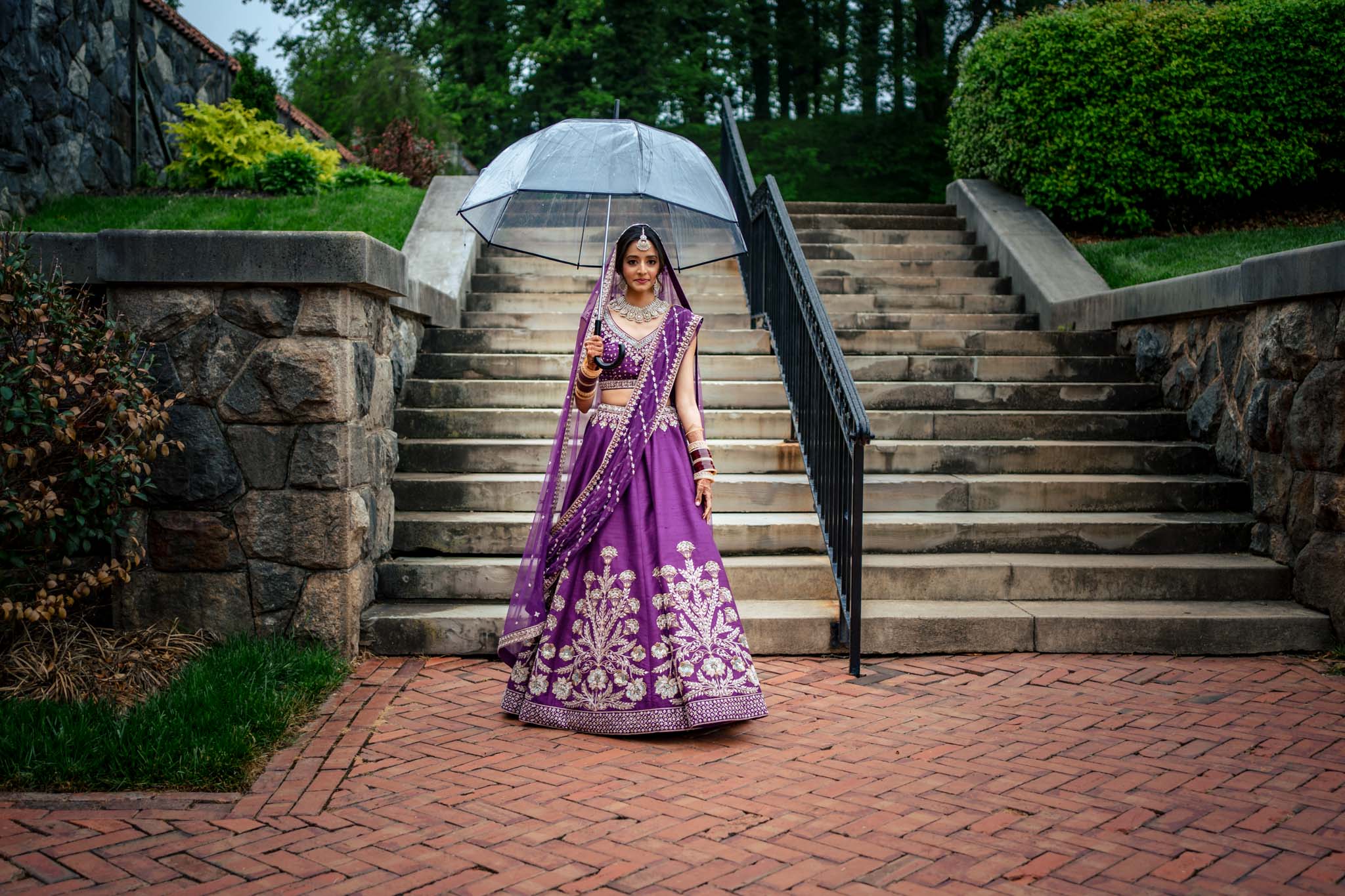 A Biltmore Estate wedding with an Indian bride holding an umbrella.