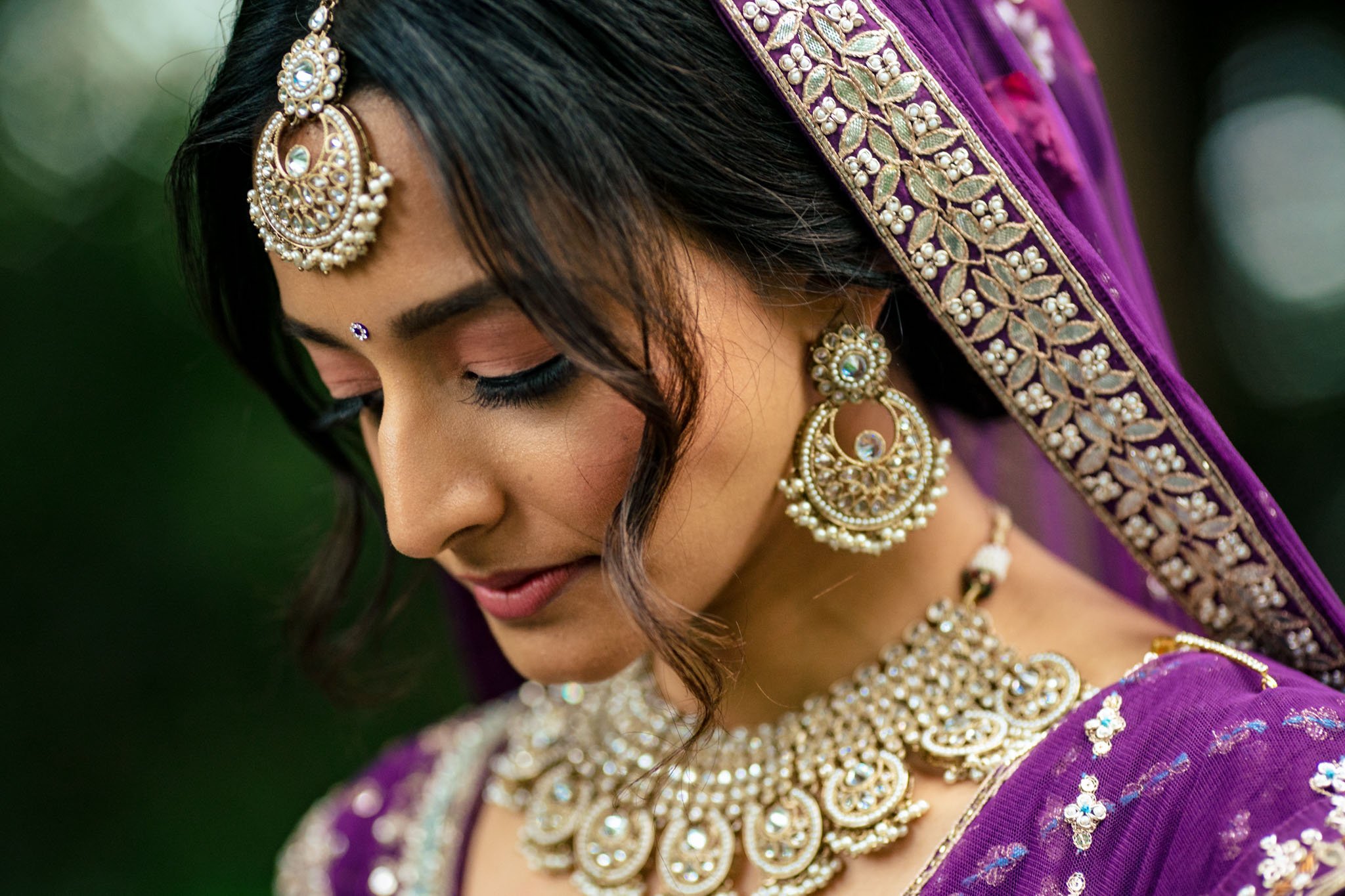 A beautiful Indian bride in a purple sari at a Biltmore Estate wedding.