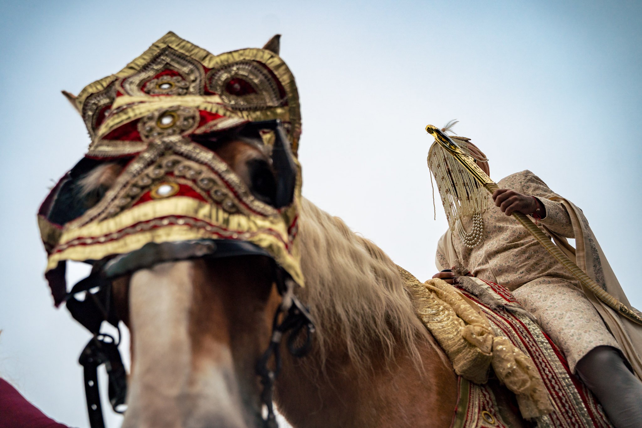 A man on a horse at a Biltmore Estate wedding wearing an Indian headdress.