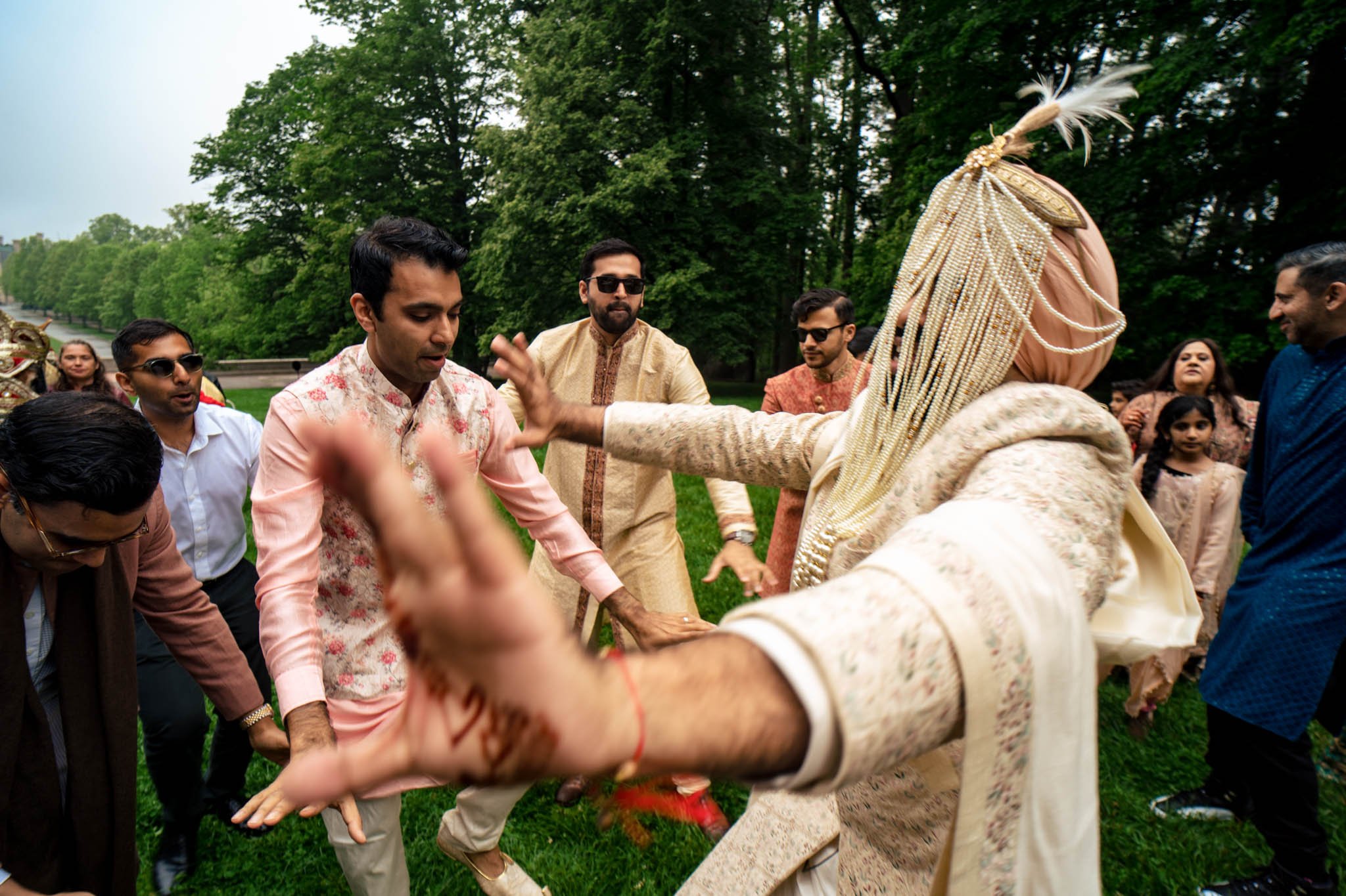 A group of Indian men performing traditional dance at a Biltmore Estate wedding.